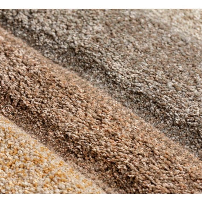 Close-up of beige and brown carpet texture.