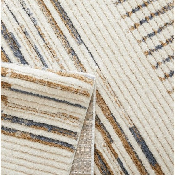 Close-up of a modern area rug with textured cream, tan, and blue lines.