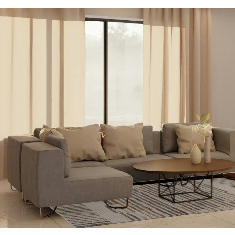 Modern living room with gray sectional sofa, beige pillows, coffee table, and neutral curtains.