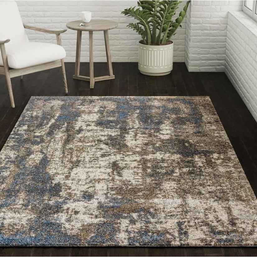 Area rug with abstract blue and brown pattern in a modern living room setting.