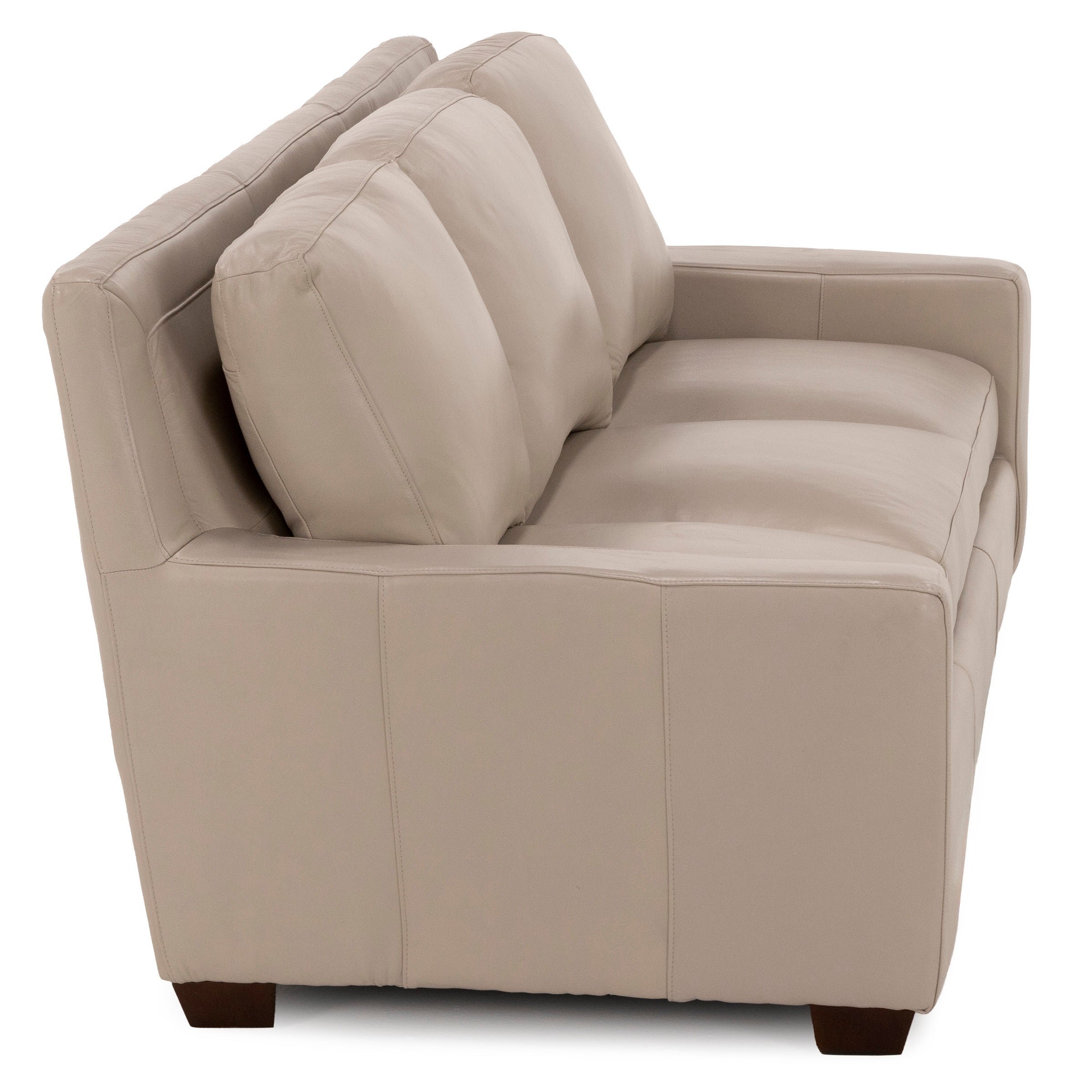 Beige leather loveseat with plush cushions, viewed from the side.