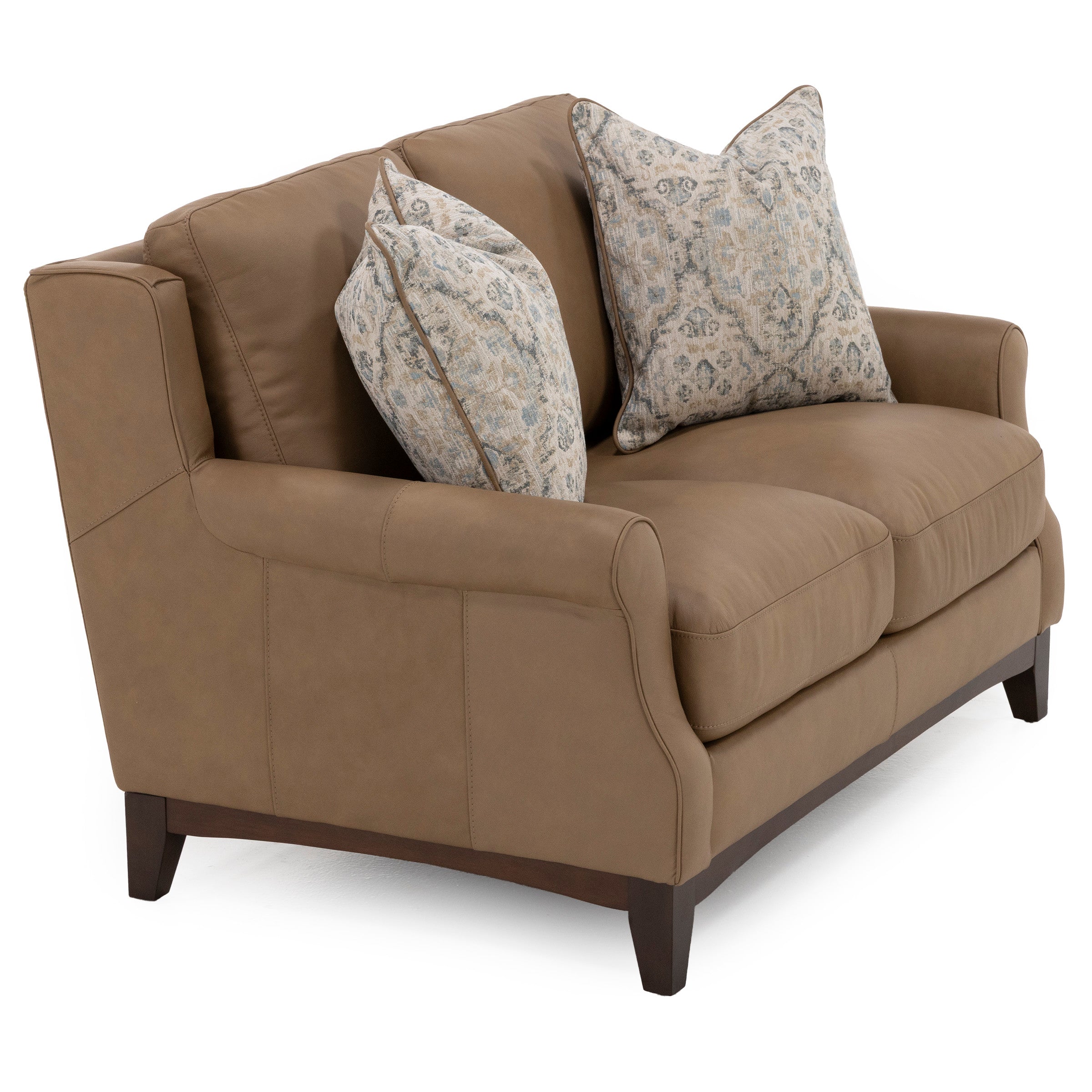 Tan loveseat sofa with two patterned throw pillows.