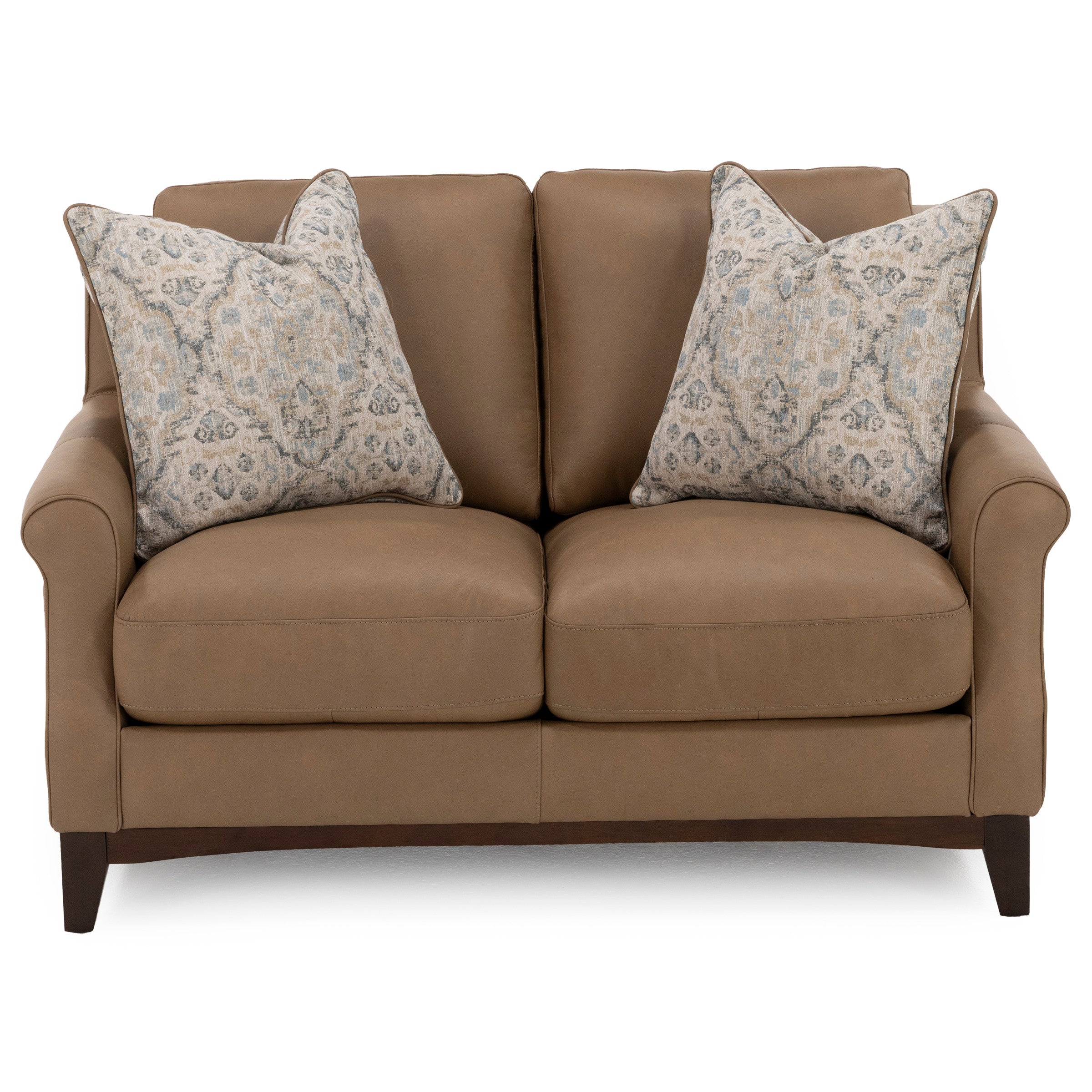 Brown leather loveseat with two patterned throw pillows.