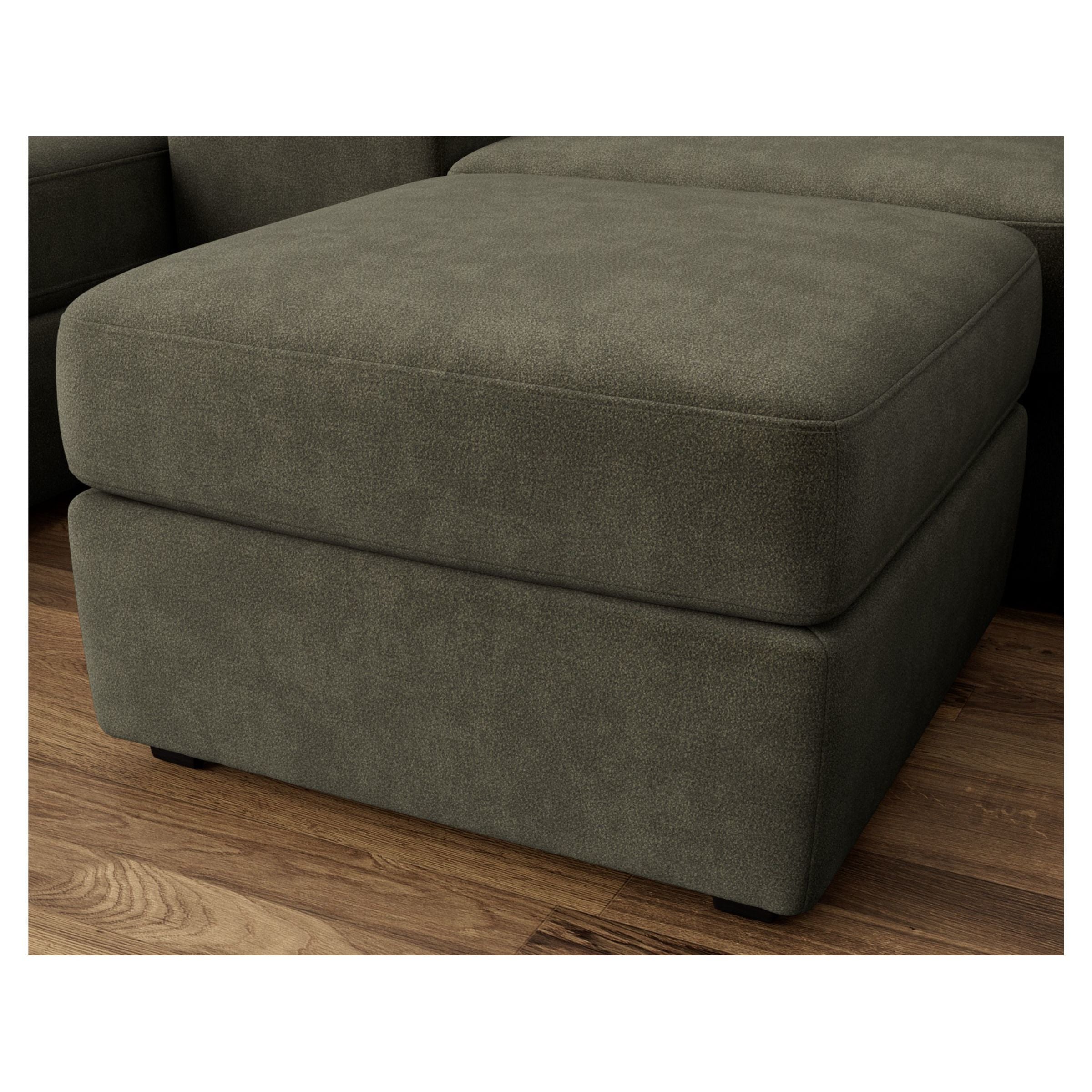 Olive green upholstered ottoman on wood floor.