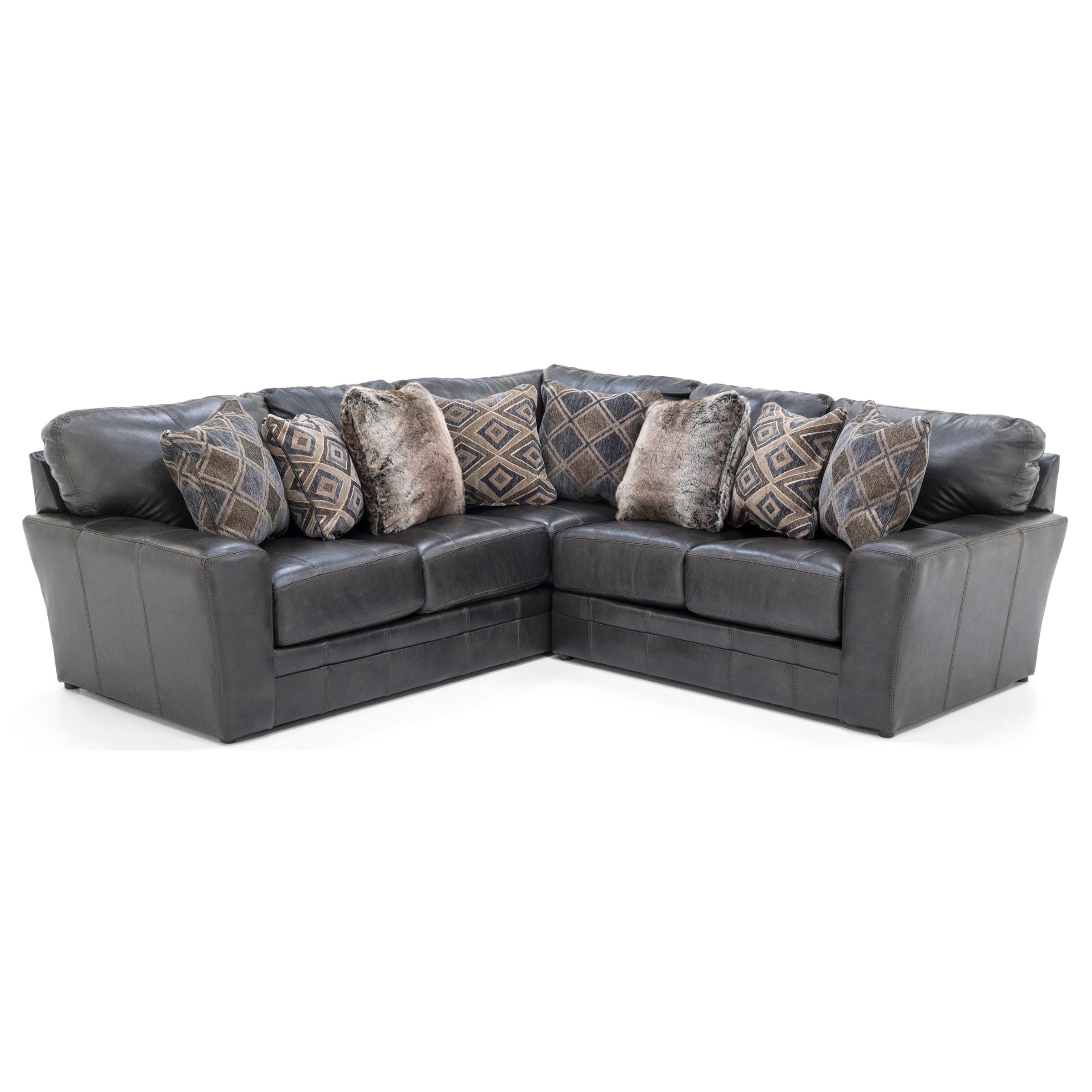 Dark gray sectional sofa with patterned and faux fur pillows.
