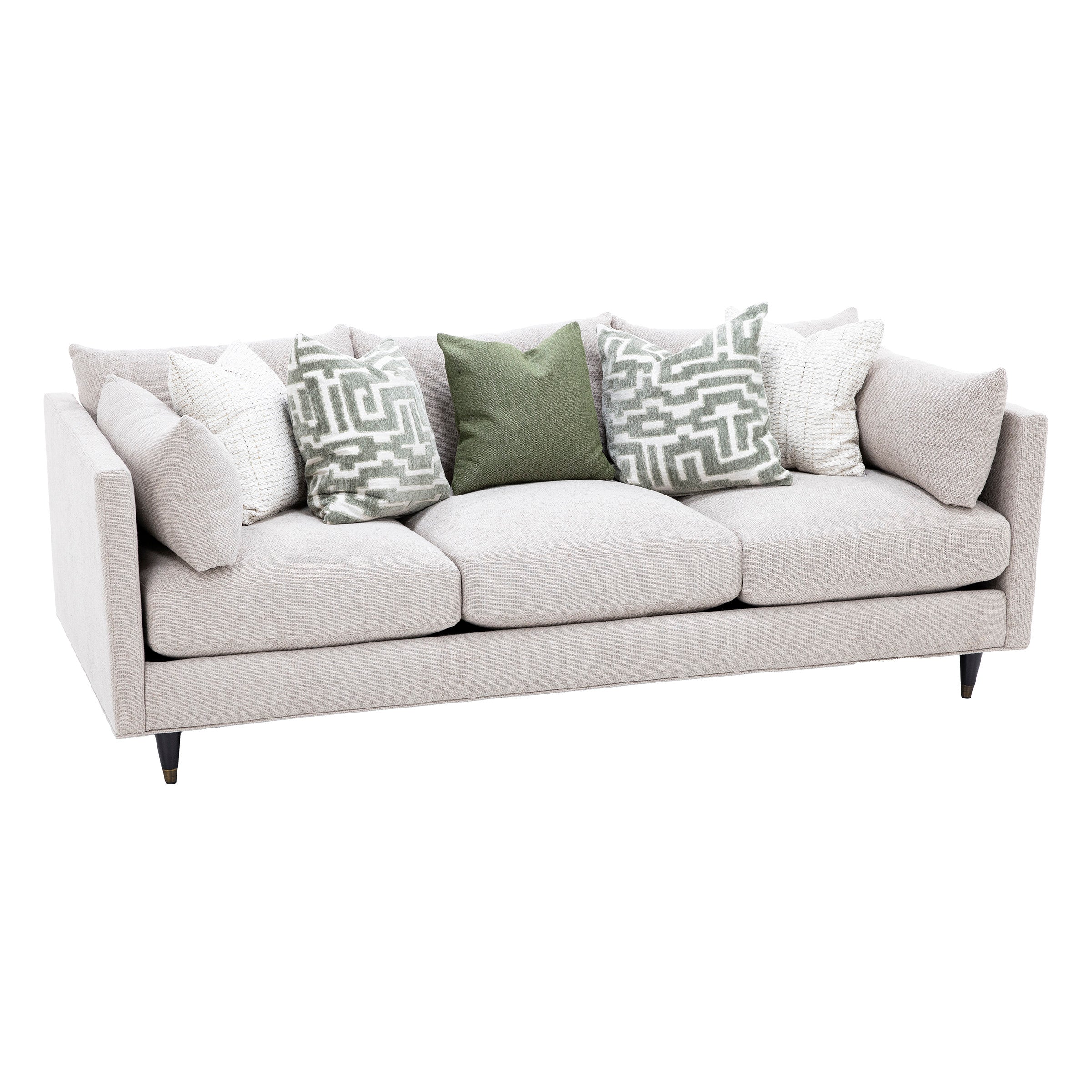 Modern light beige sofa with patterned and plain throw pillows.