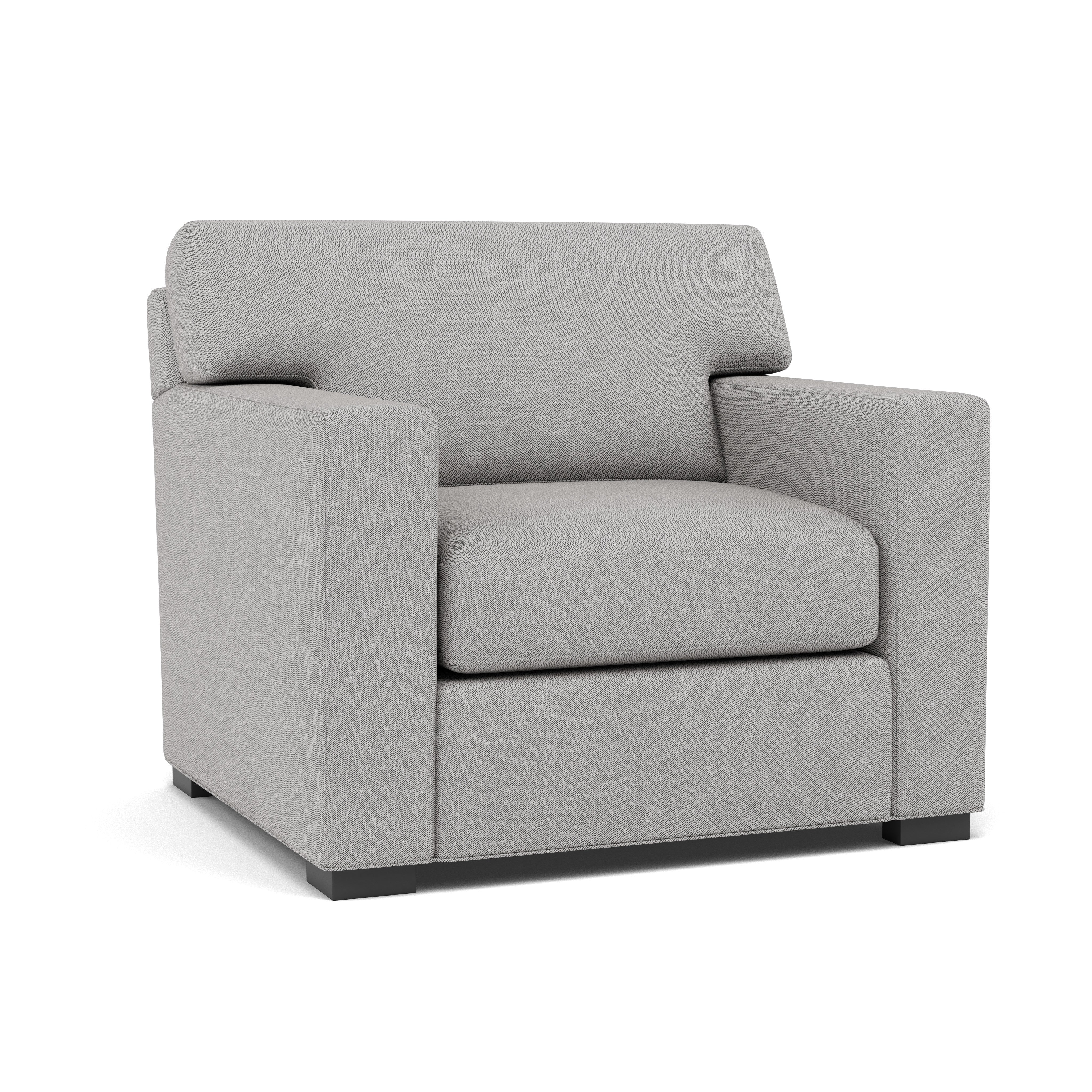 Modern gray armchair with boxy design, upholstered with fabric, ideal for living room seating.