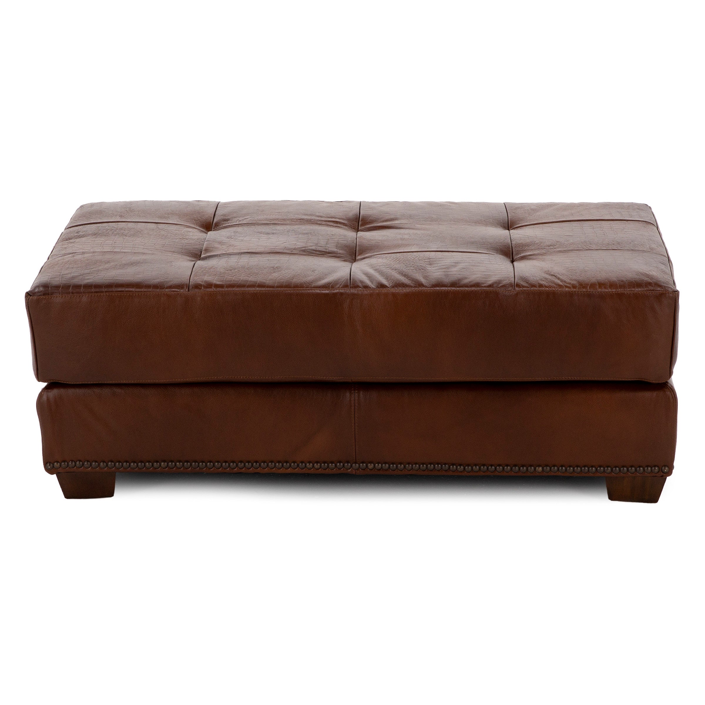 Brown tufted leather ottoman with nailhead trim and block feet.