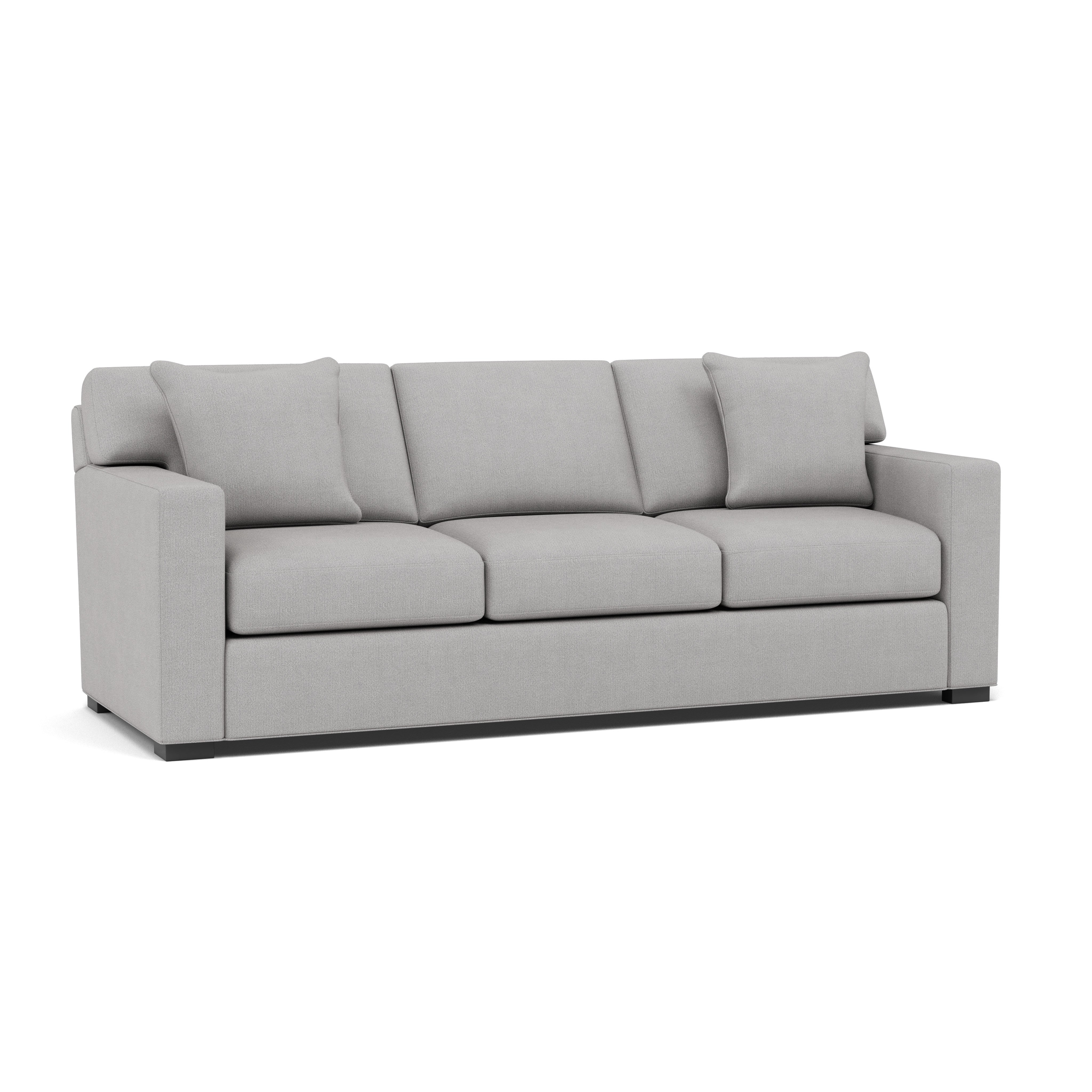 Light gray modern sofa with three cushions and two pillows, suitable for living rooms.