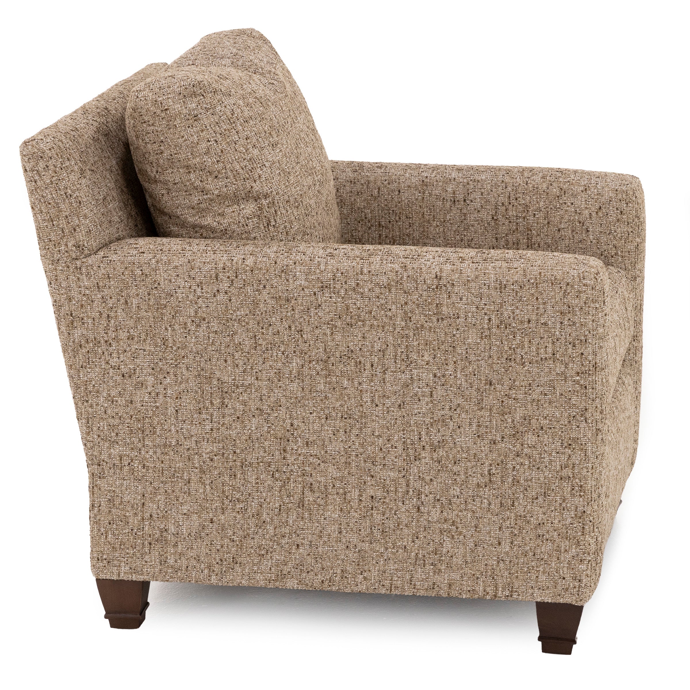 Side view of a tan upholstered armchair with squared arms and wooden legs.