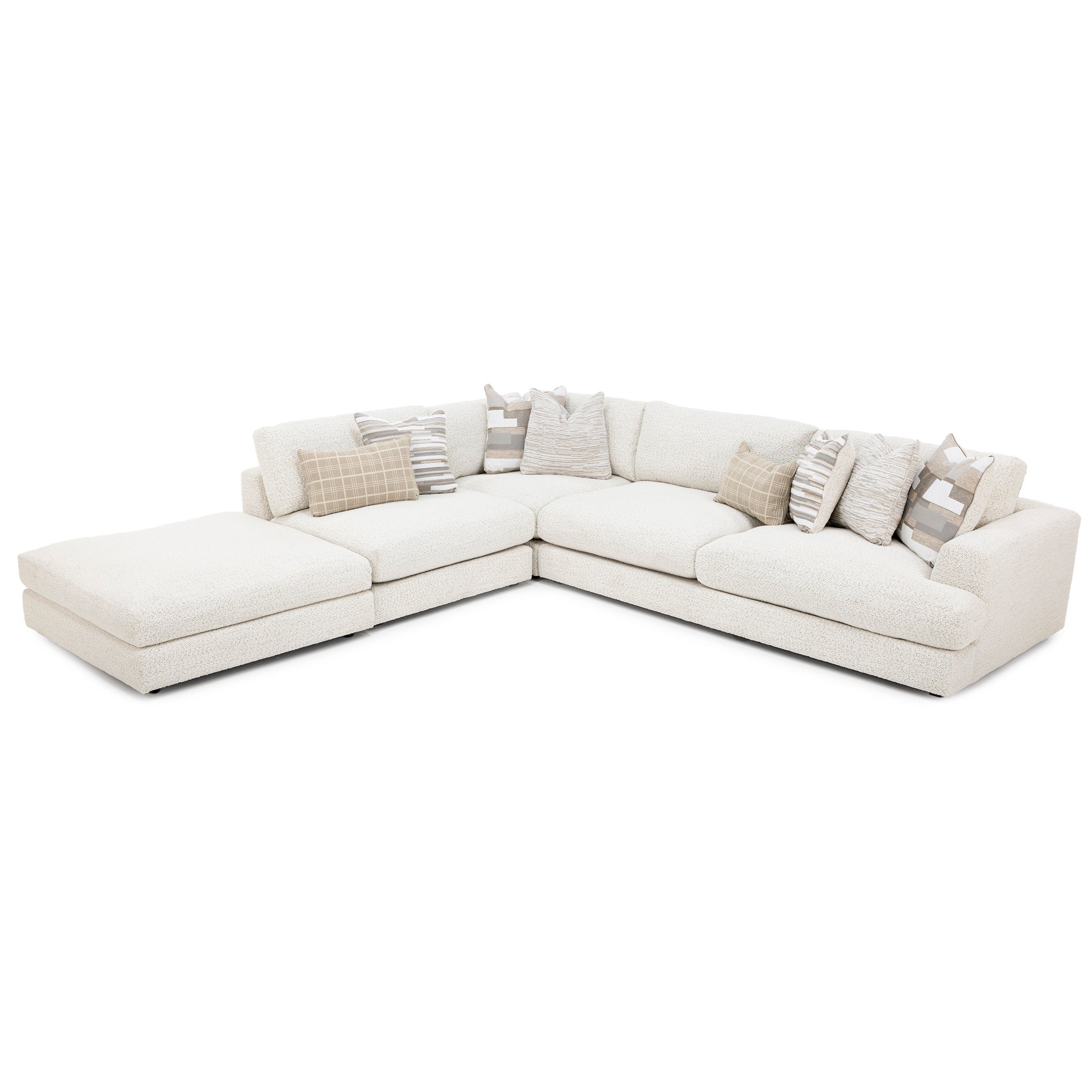 Off-white L-shaped sectional sofa with assorted neutral throw pillows.