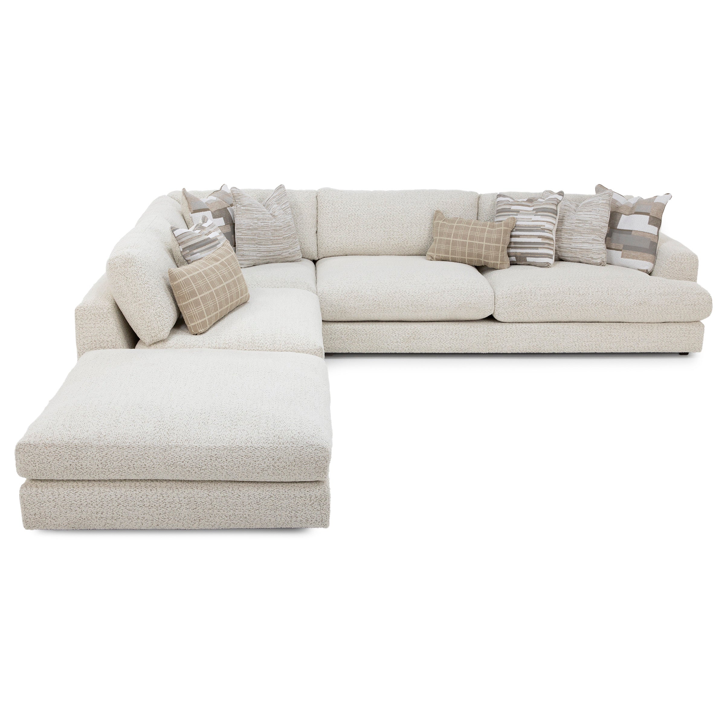 L-shaped cream sectional sofa with textured fabric and assorted neutral throw pillows.