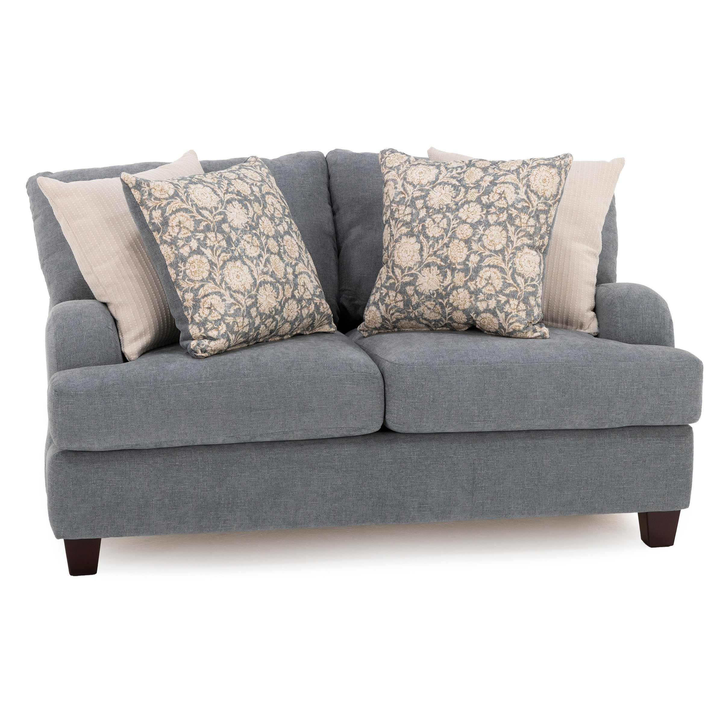Gray upholstered sofa with four decorative pillows, two floral and two solid.
