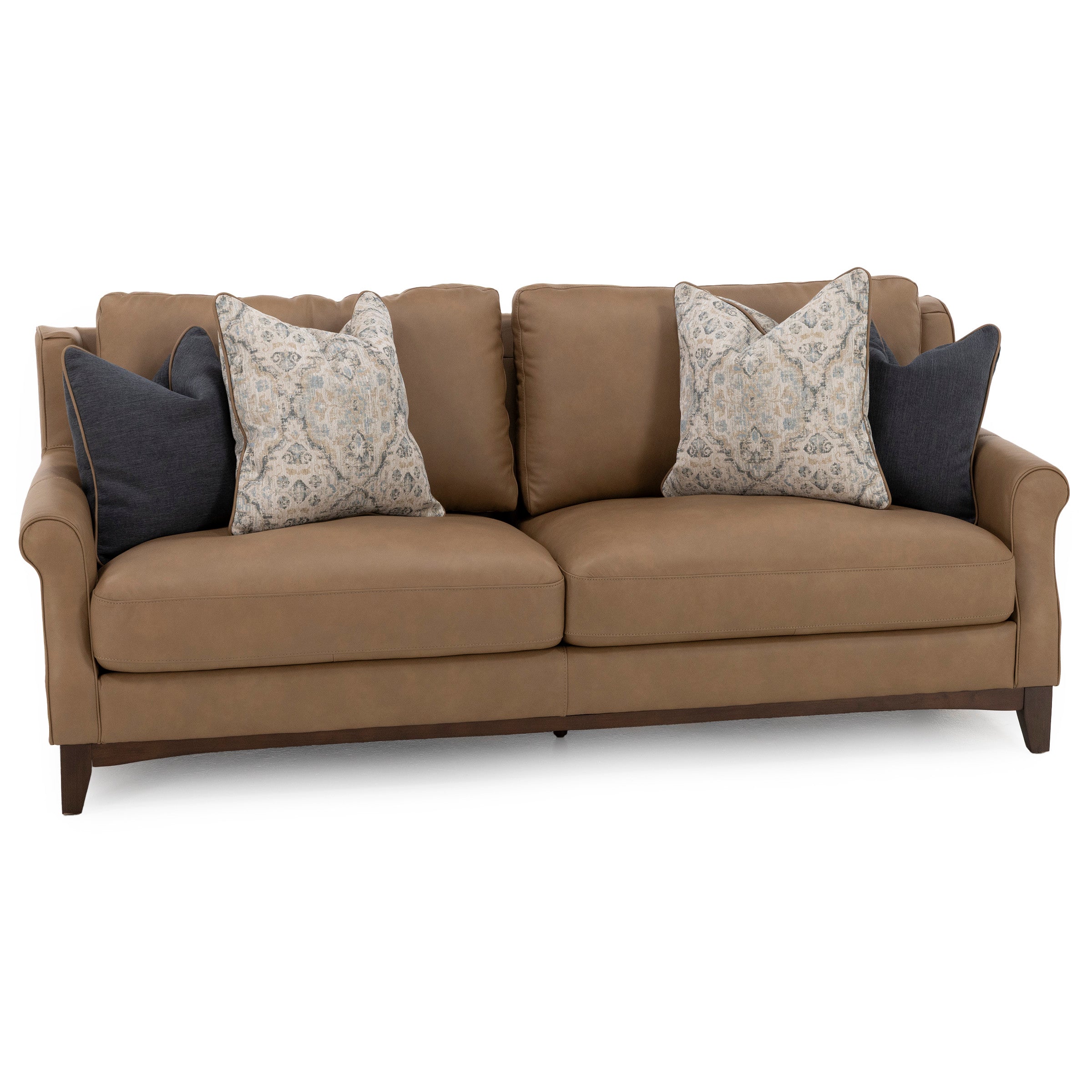 Brown sofa with four decorative pillows, two patterned and two solid dark blue.