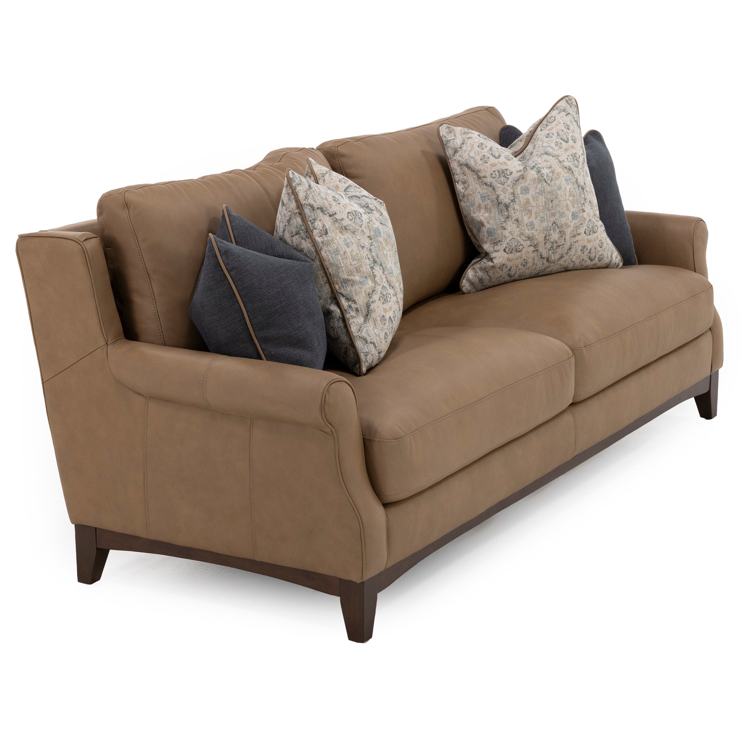 Brown leather sofa with dark wood legs and patterned throw pillows.