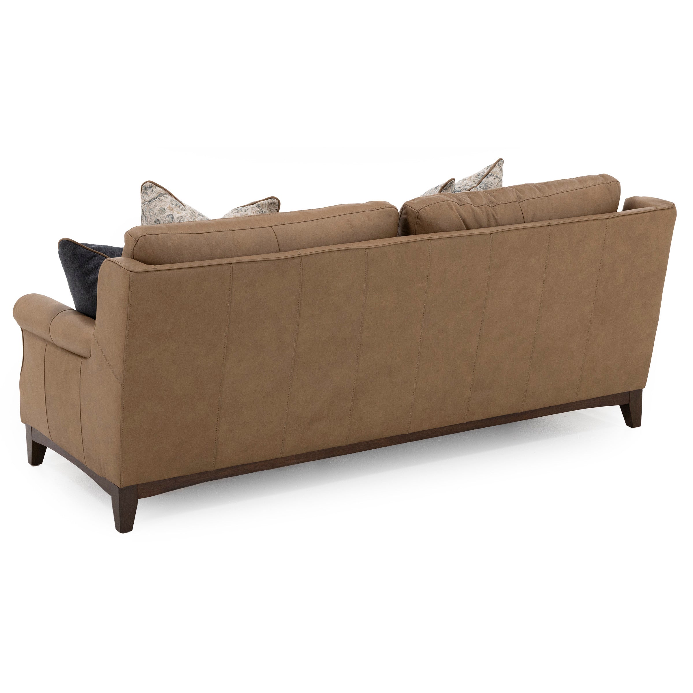 Back view of a tan leather sofa with pillows on the seats.