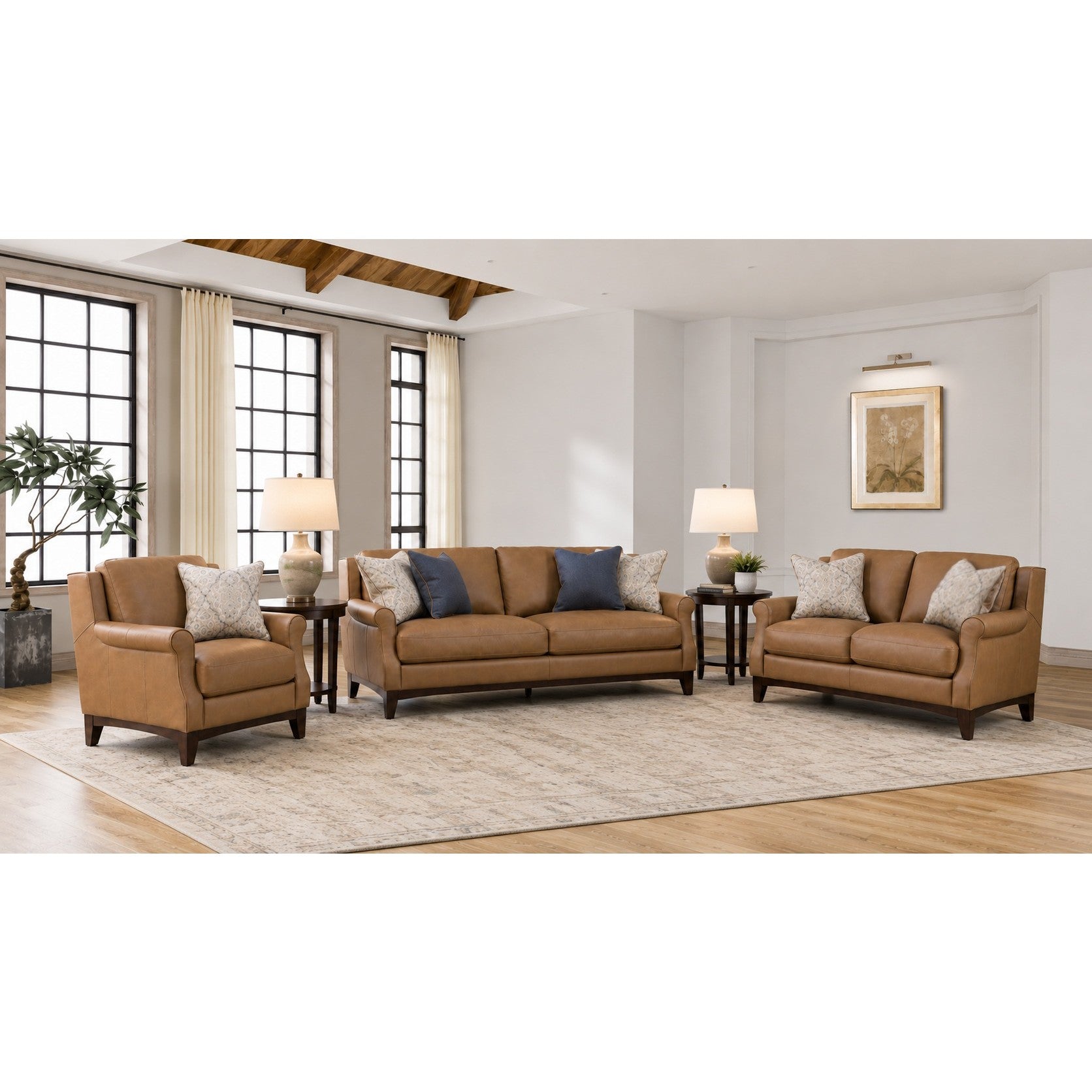 Tan leather sofa set with accent pillows in a modern living room.