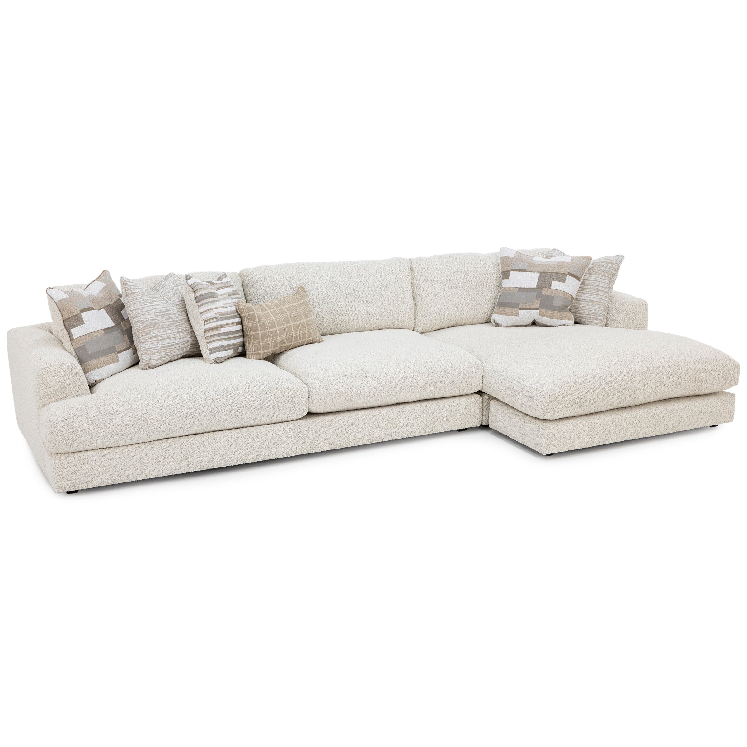 Cream sectional sofa with chaise and assorted neutral throw pillows.