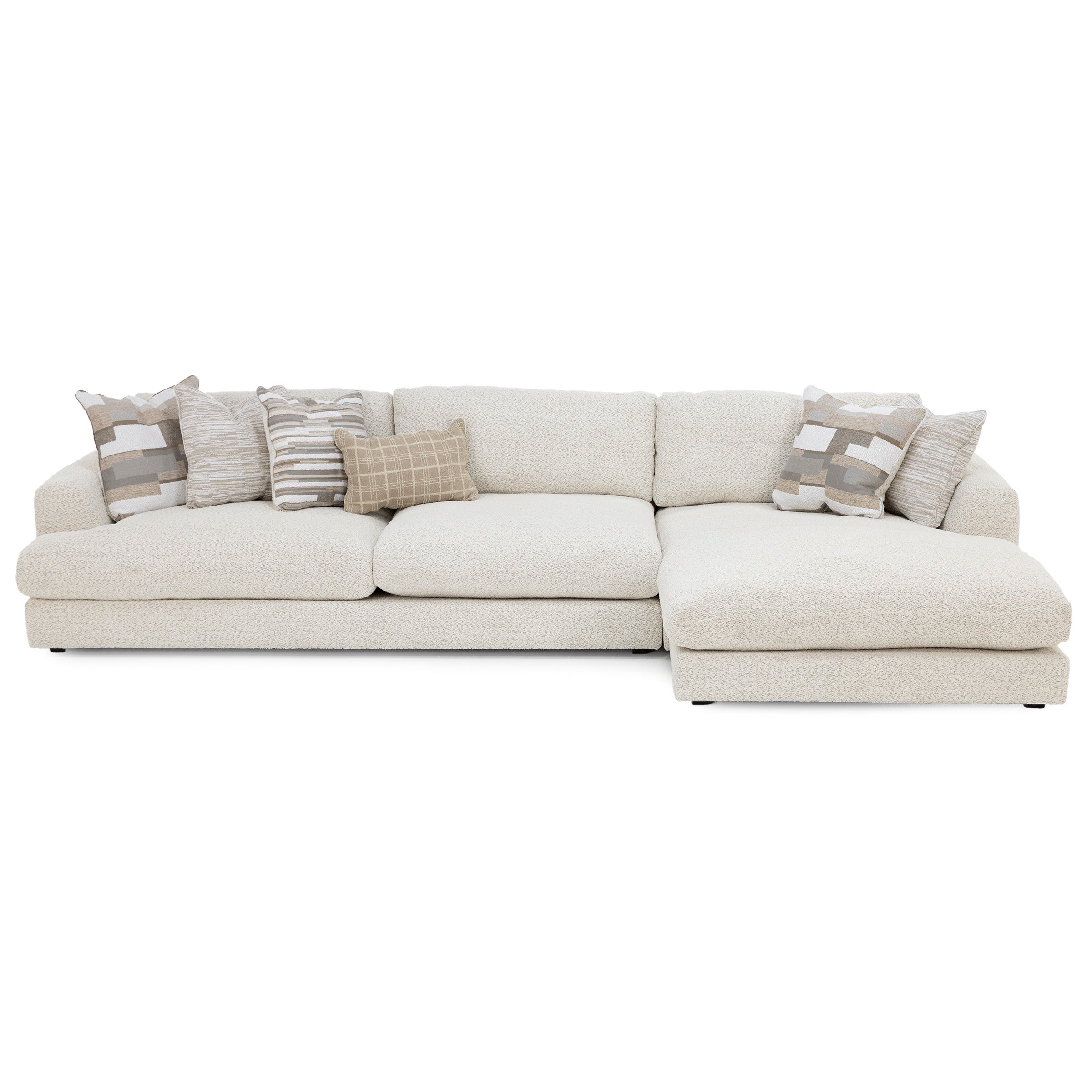 Cream sectional sofa with decorative pillows, suitable for modern living rooms.