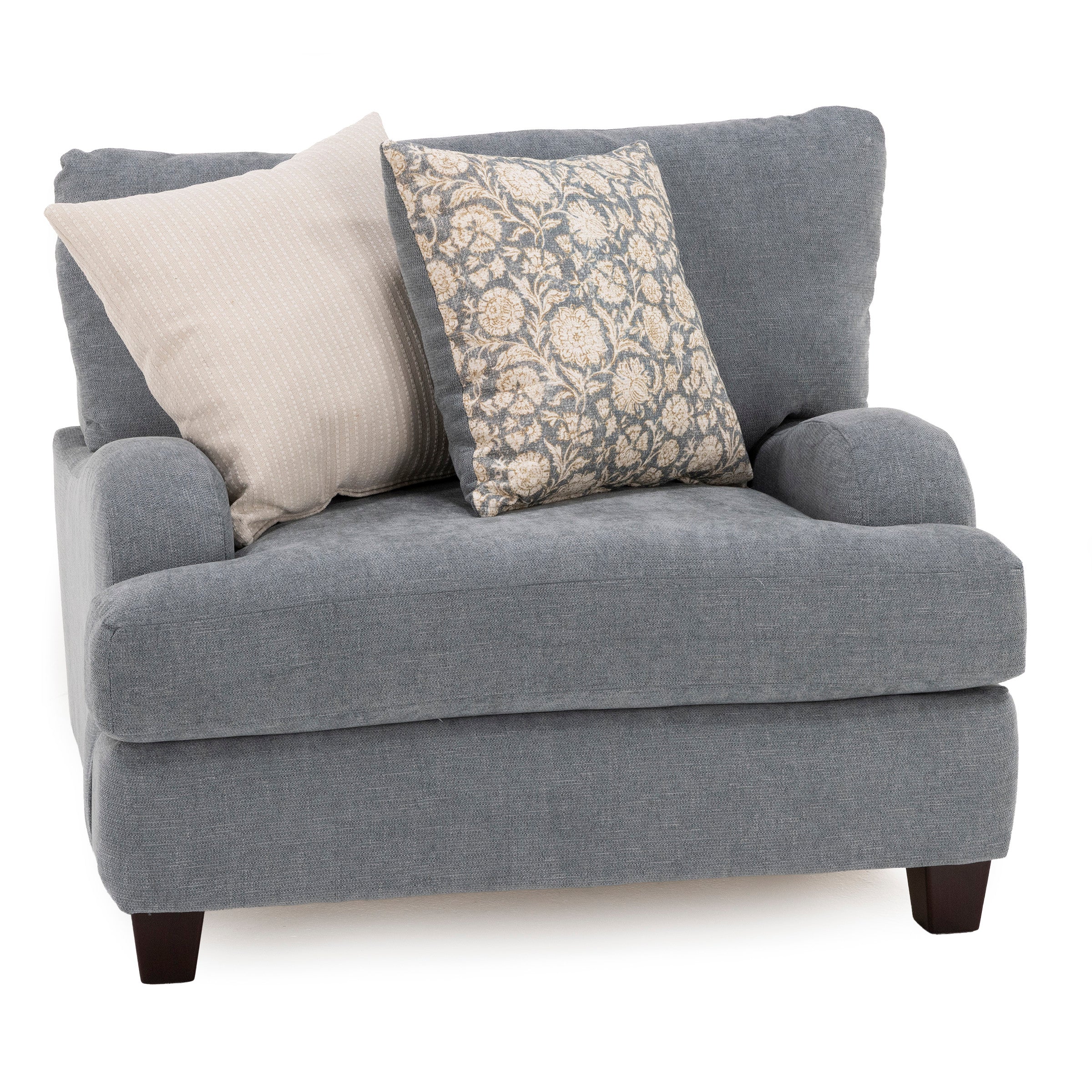 Gray upholstered armchair with two decorative pillows, one patterned and one solid.