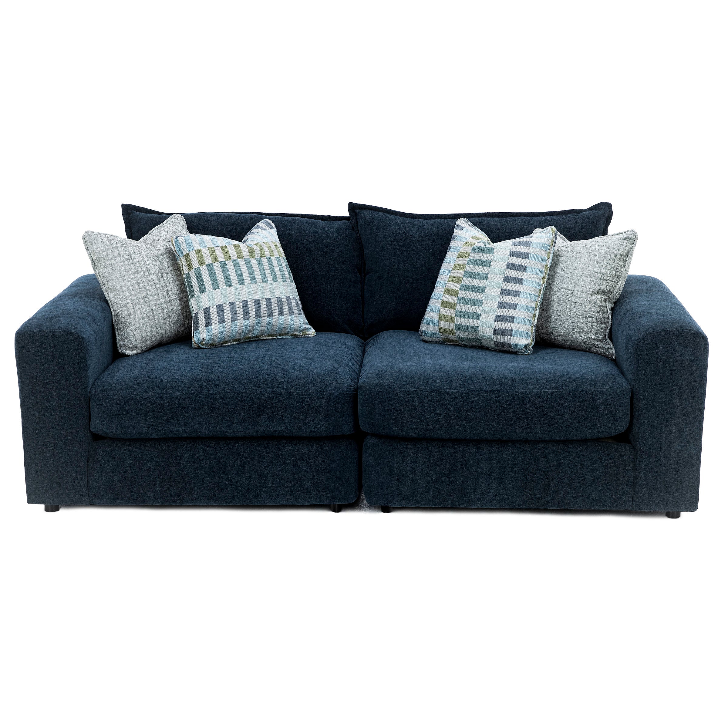Navy blue sofa with wide arms and five decorative pillows in coordinating patterns.