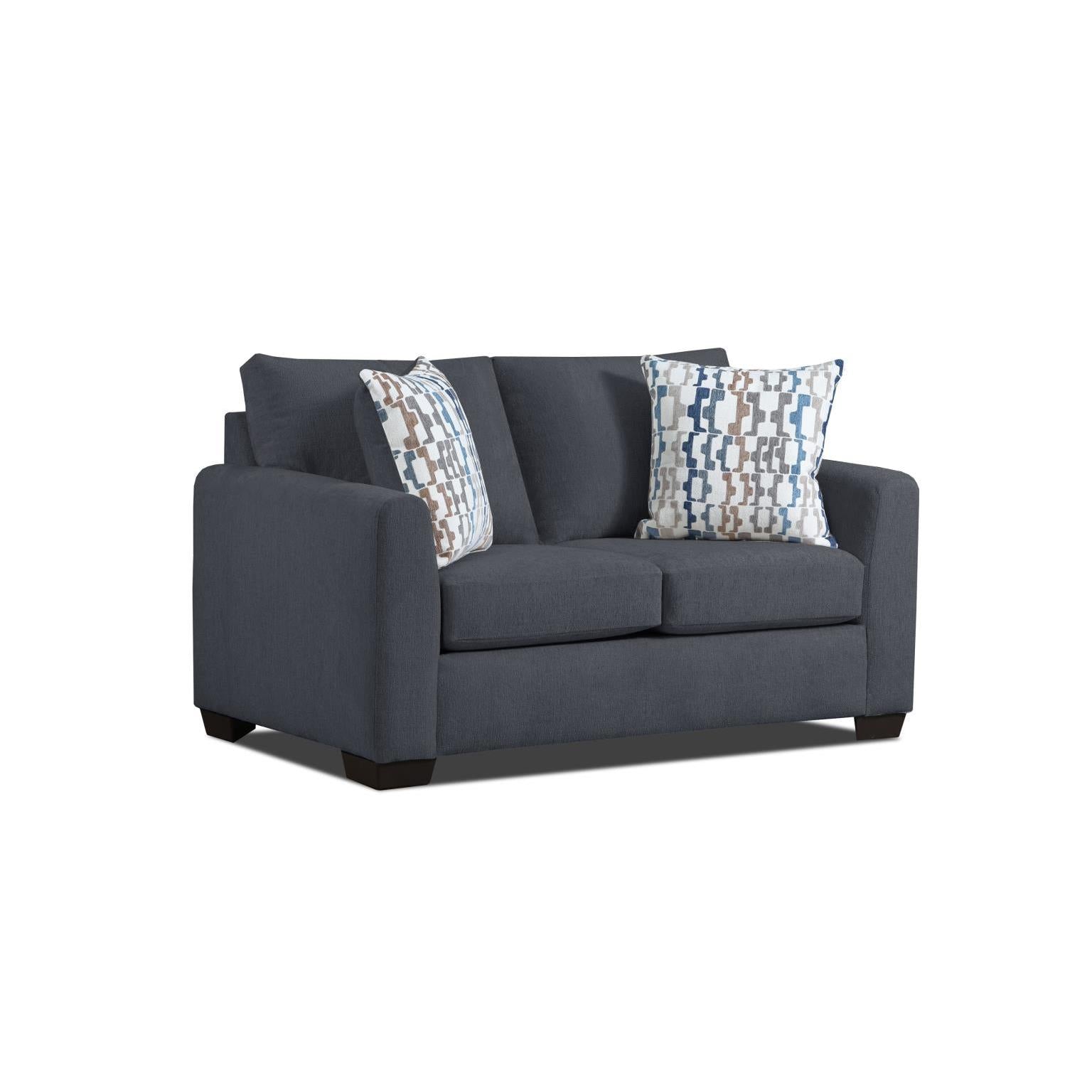 Dark blue loveseat sofa with two patterned accent pillows.