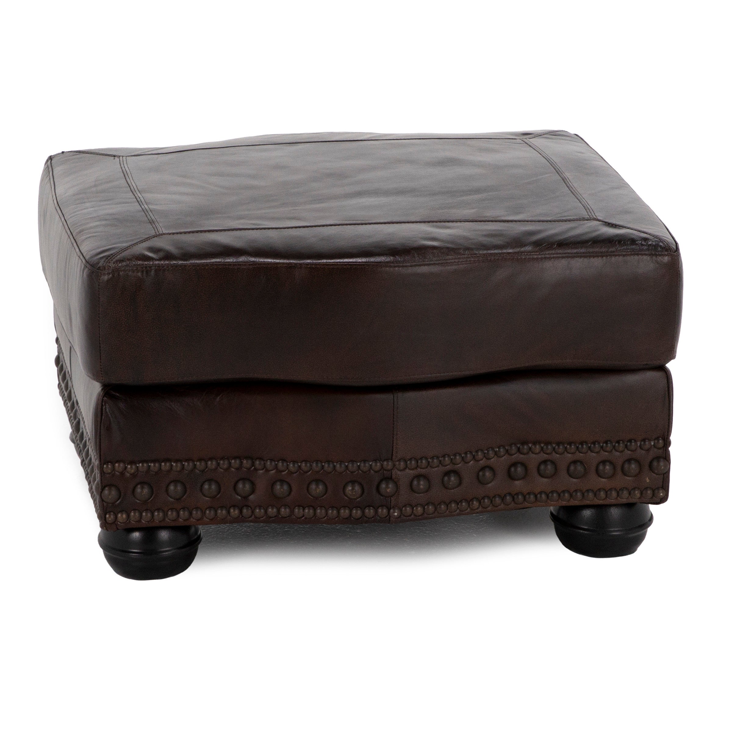 Square dark brown leather ottoman with decorative nailhead trim and short rounded legs.