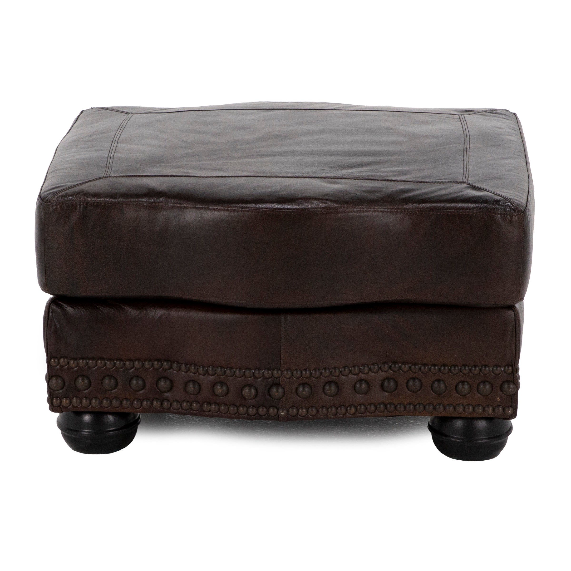 Dark brown leather ottoman with decorative nailhead trim and short round legs.