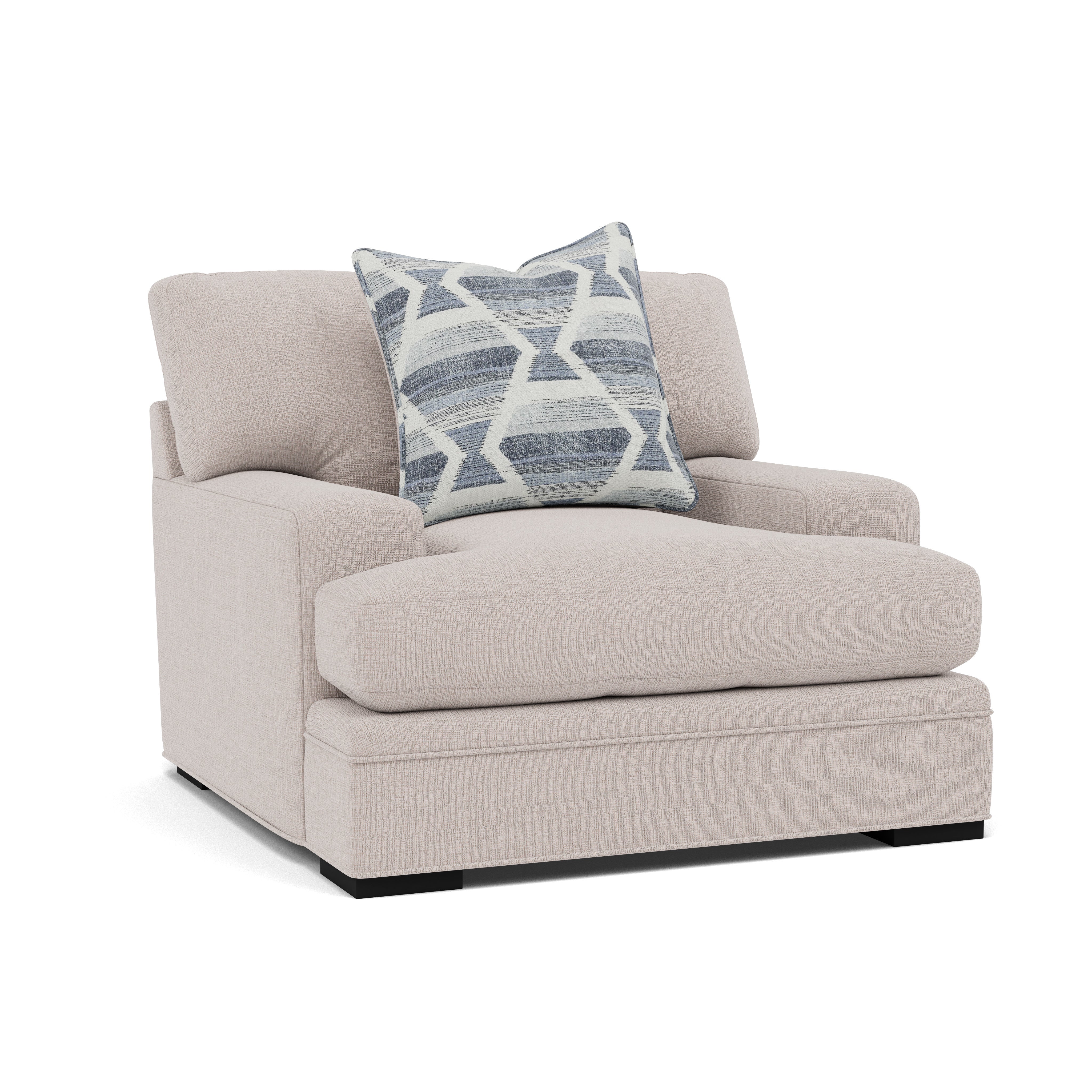 Beige upholstered armchair with a blue and white geometric pillow.