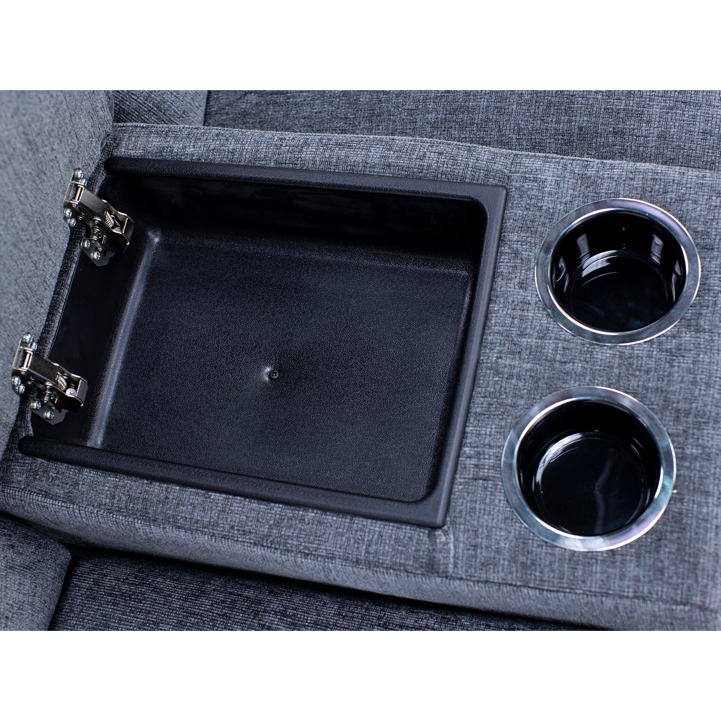 Open storage compartment and cup holders on gray upholstered furniture armrest.