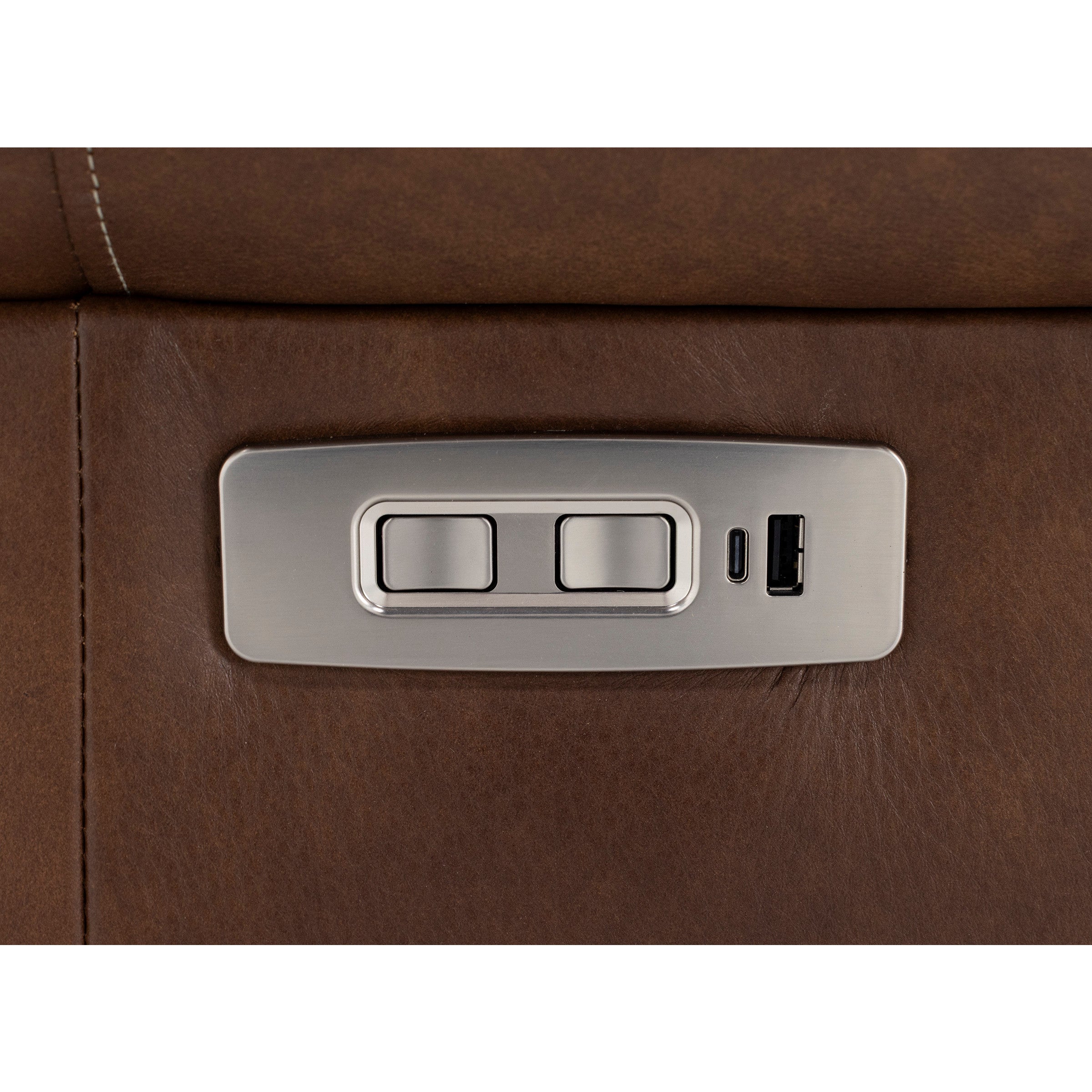 Metal control panel with buttons and USB ports on brown leather furniture.