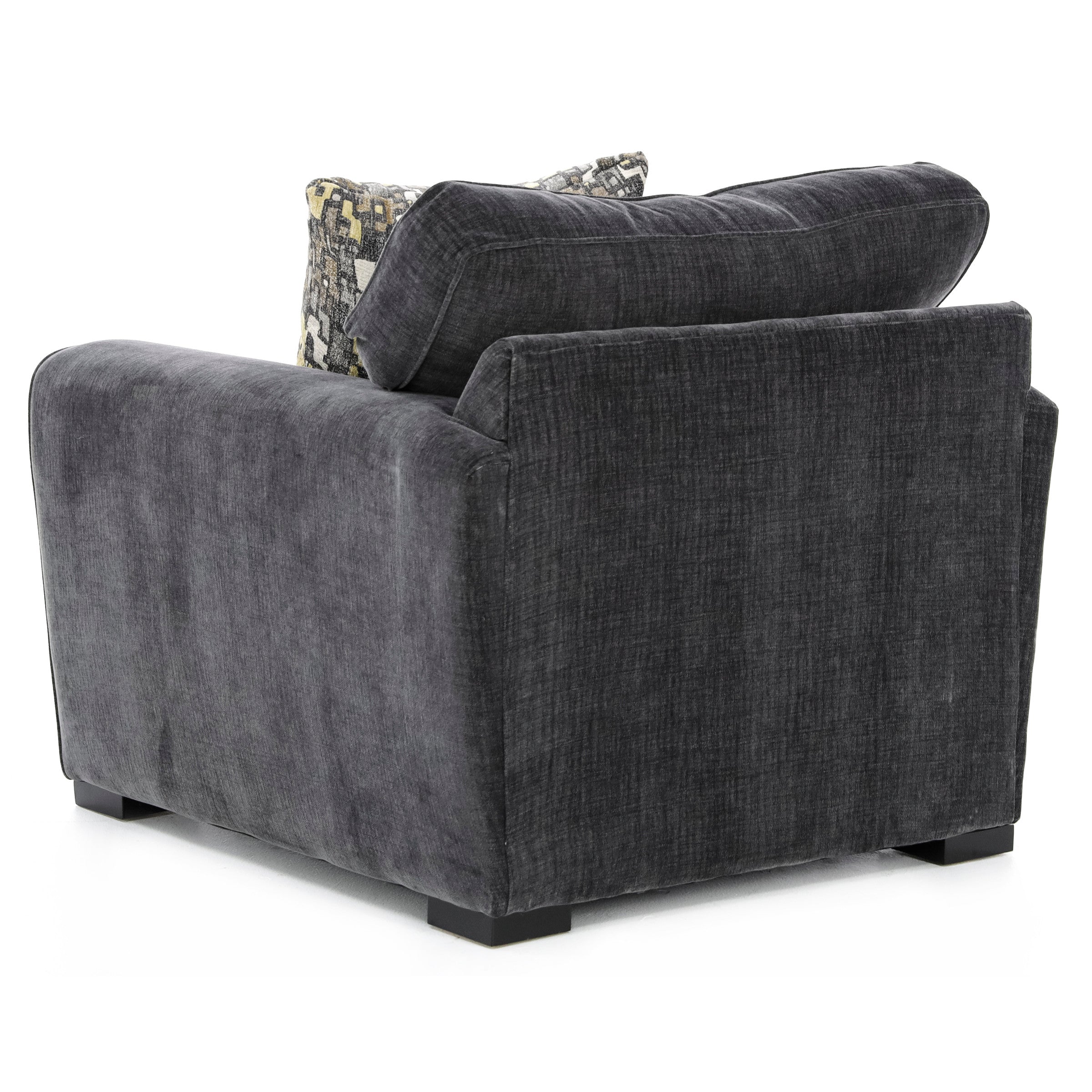 Dark gray upholstered chair with a patterned accent pillow, back and side view.
