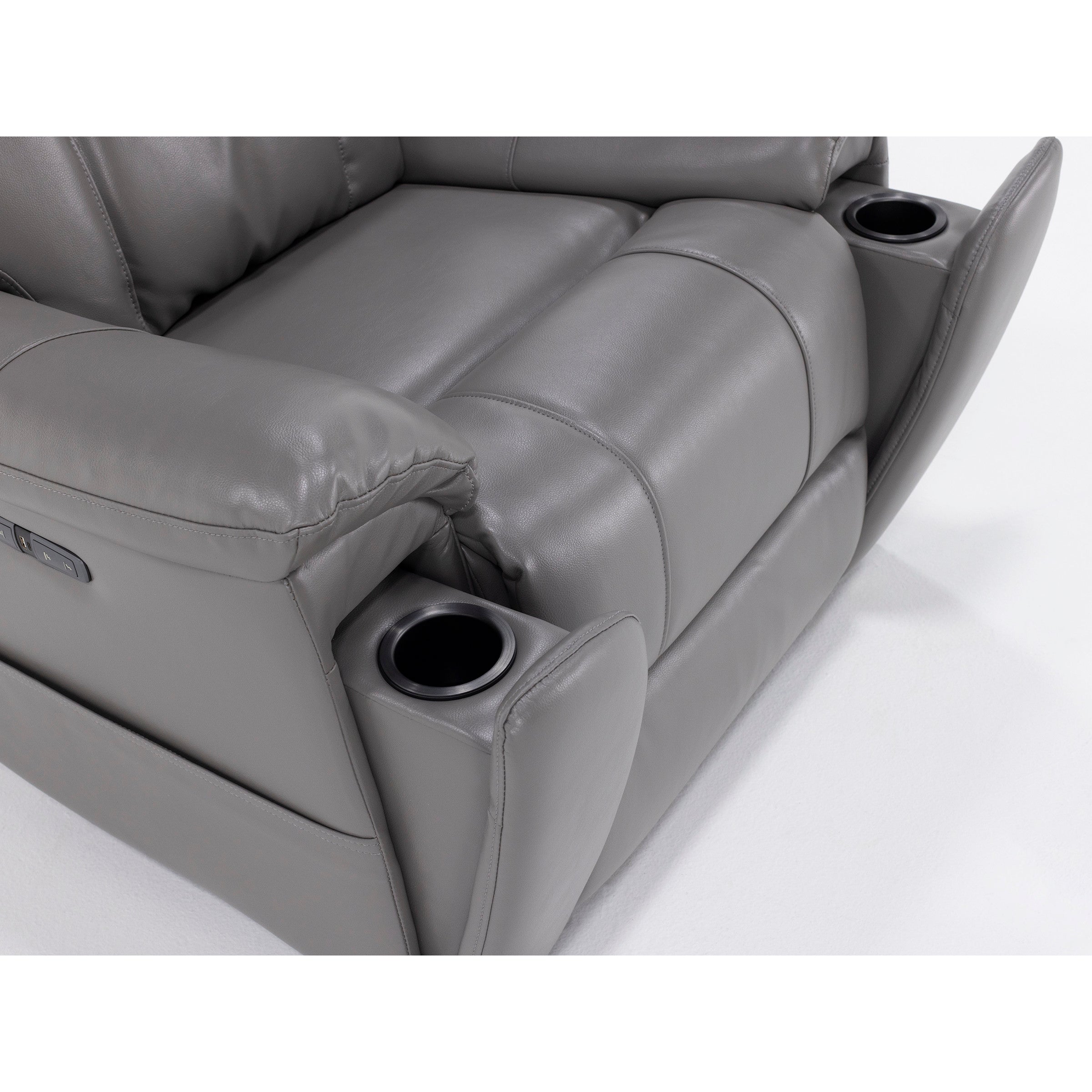 Close-up of a gray leather recliner seat with built-in cup holders in the armrests.