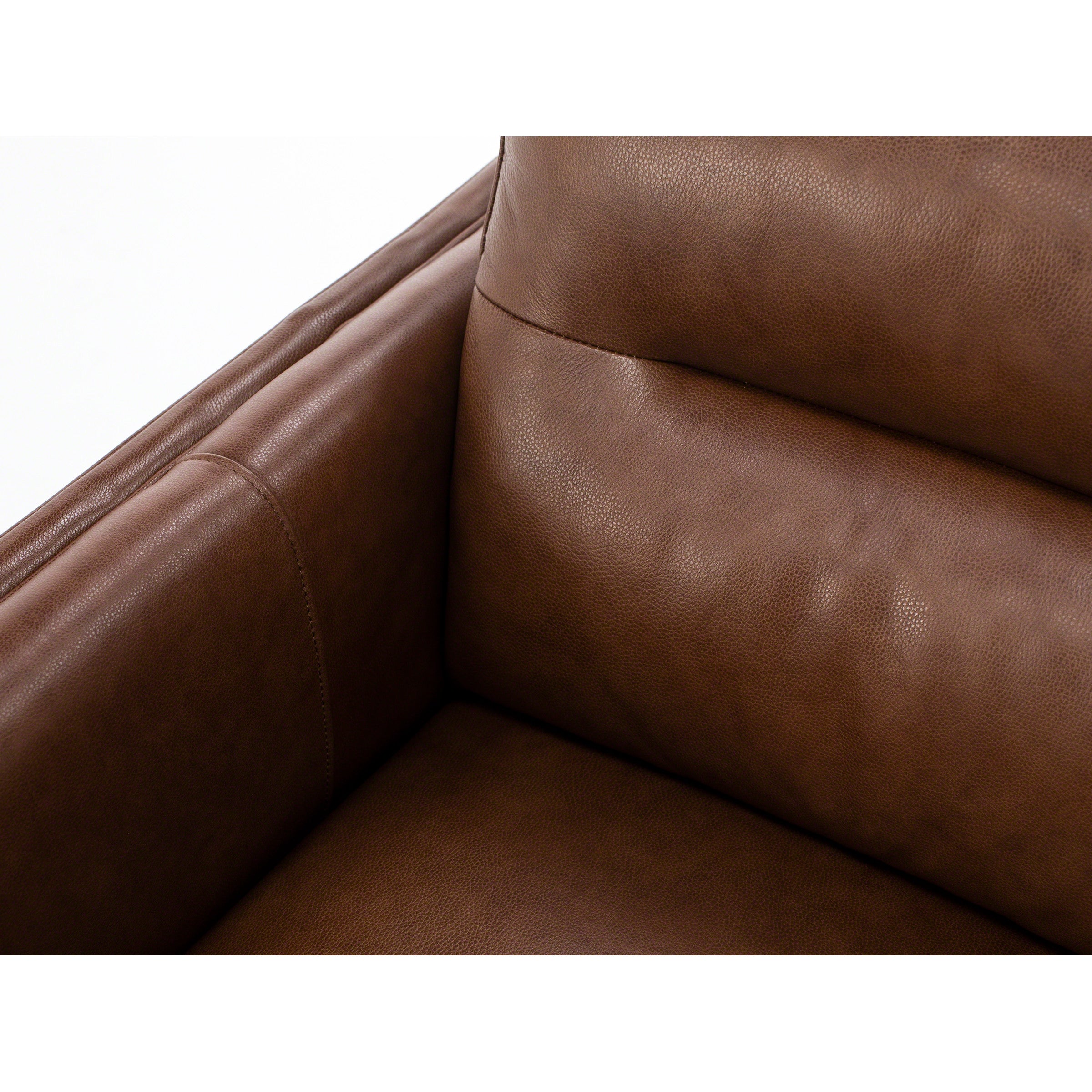 Close-up of brown leather sofa corner with visible stitching.