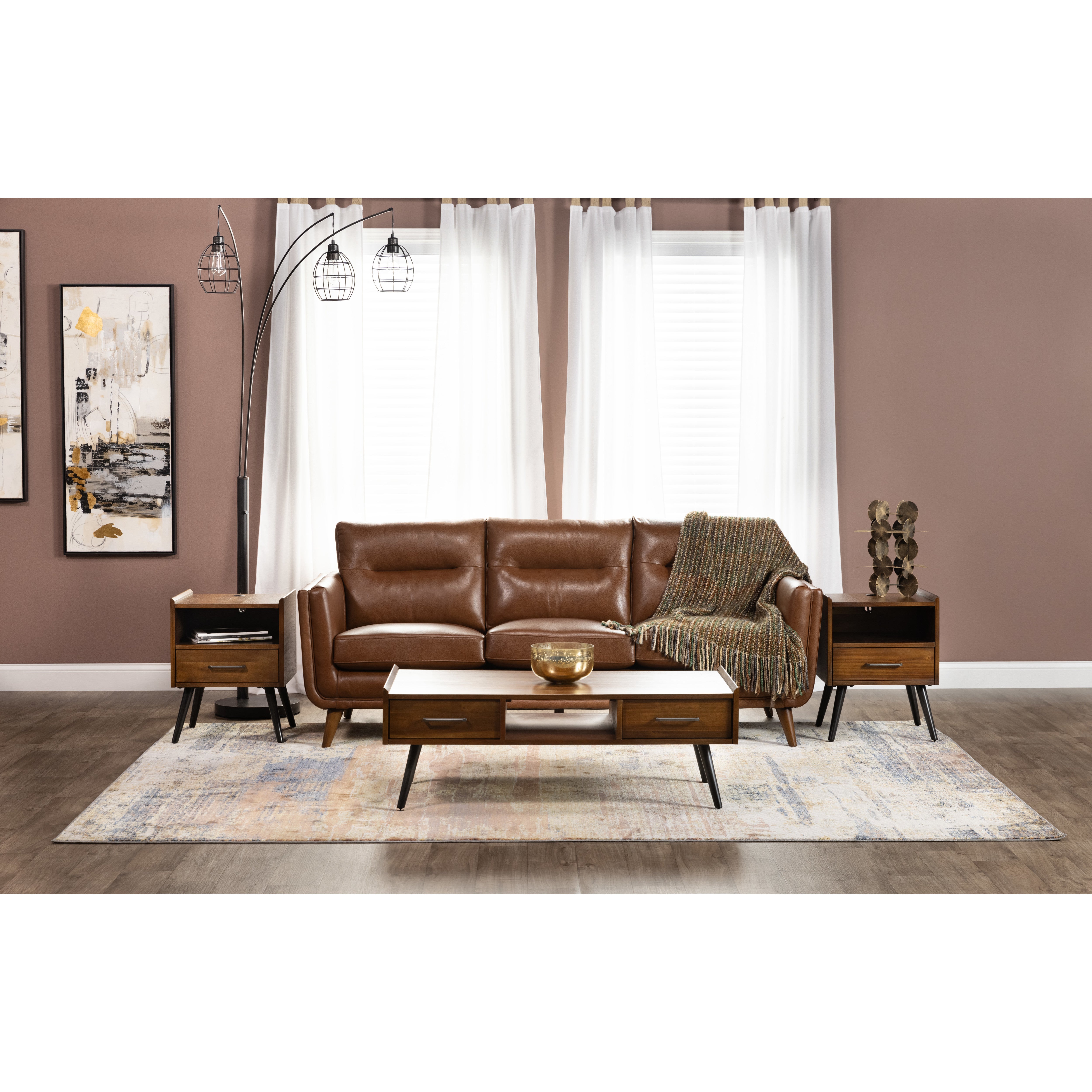 Mid-century modern living room with brown leather sofa, wood tables, and abstract art.