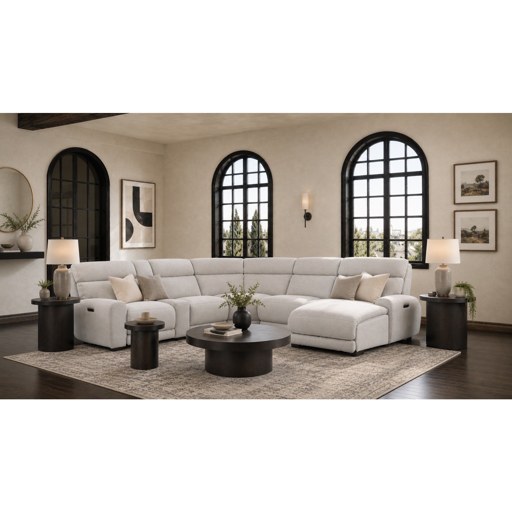 Modern living room with a light grey sectional sofa, round coffee table, and decor accents.