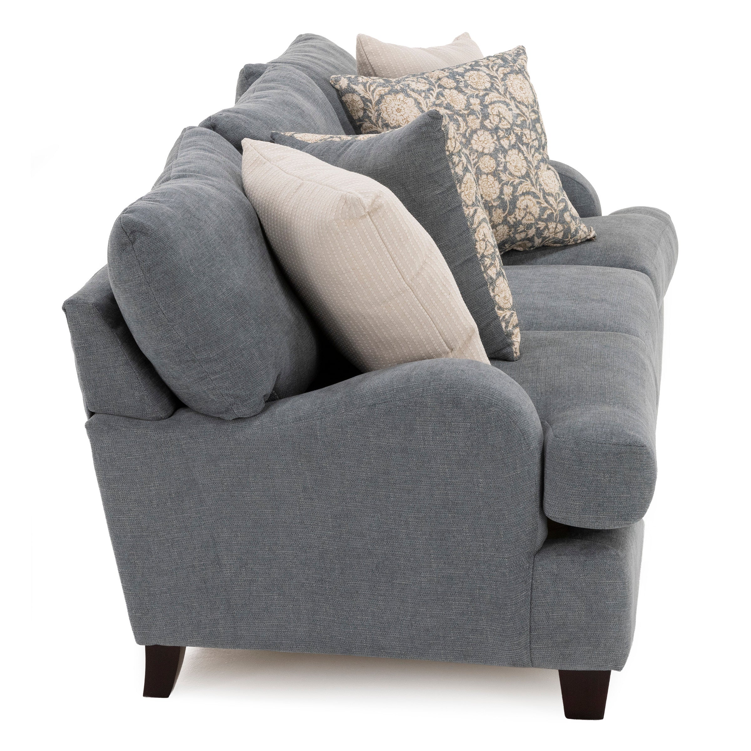 Side view of a gray upholstered sofa with several decorative pillows.