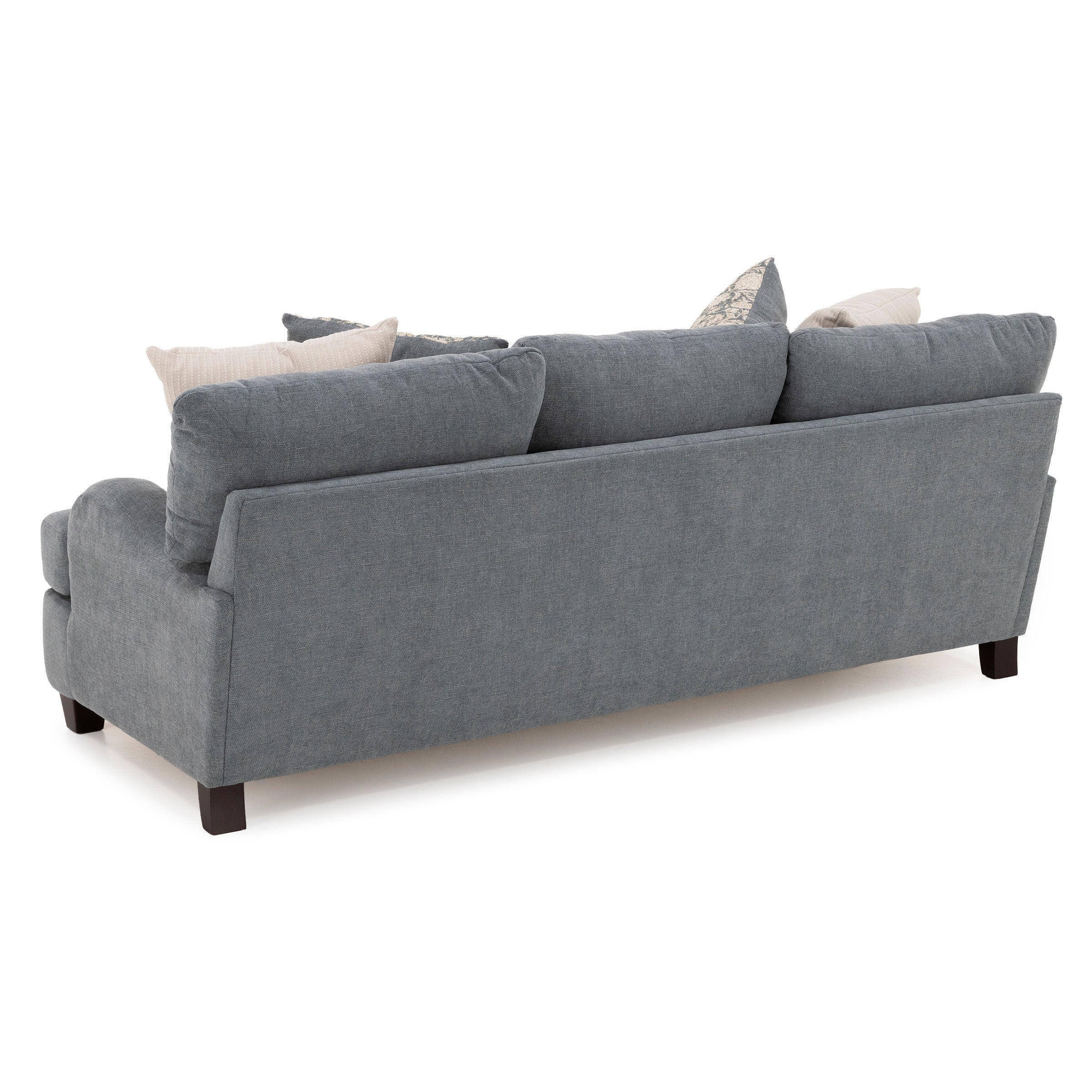 Back view of a blue upholstered sofa with multiple neutral accent pillows.