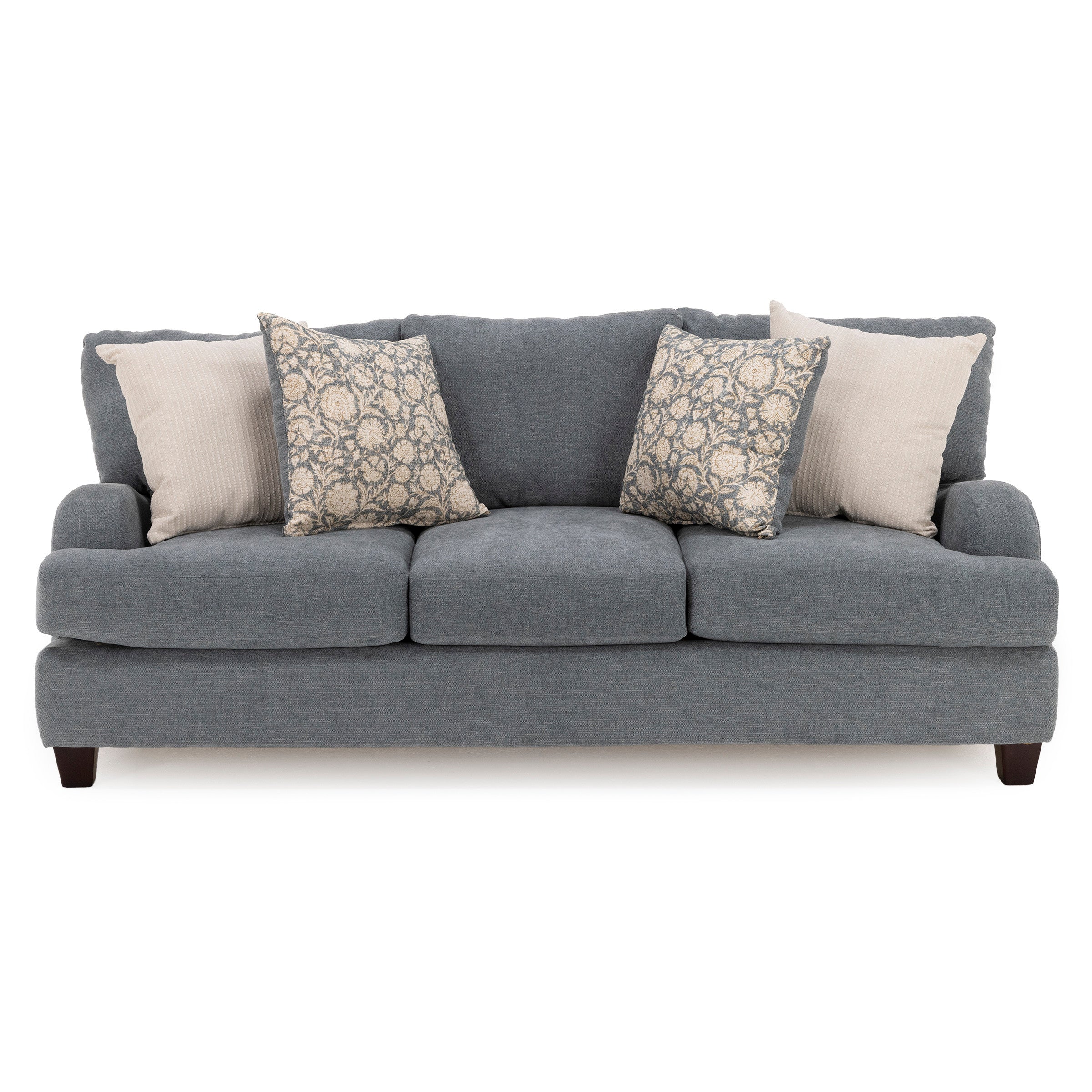 Gray three-seat sofa with four patterned and solid pillows.