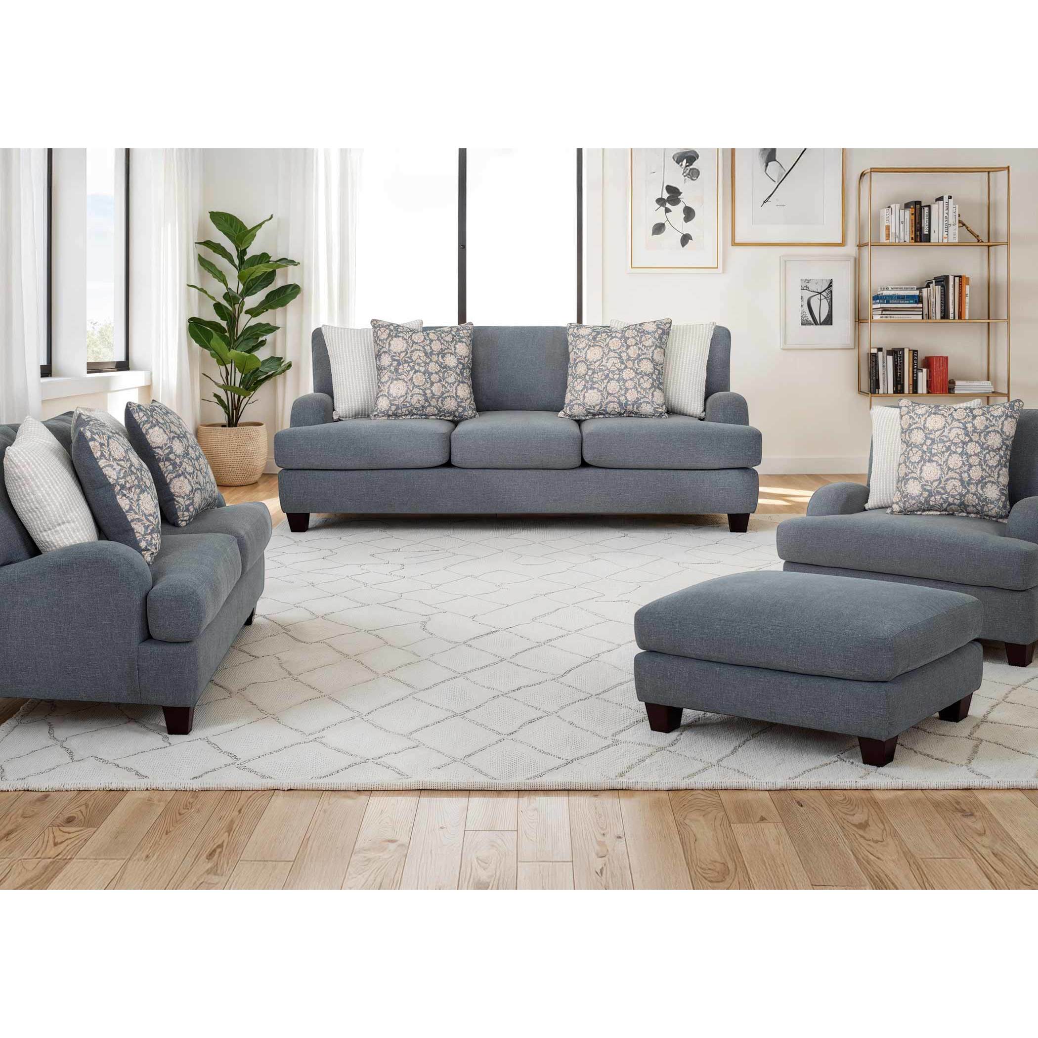 Blue upholstered living room furniture set with patterned throw pillows.