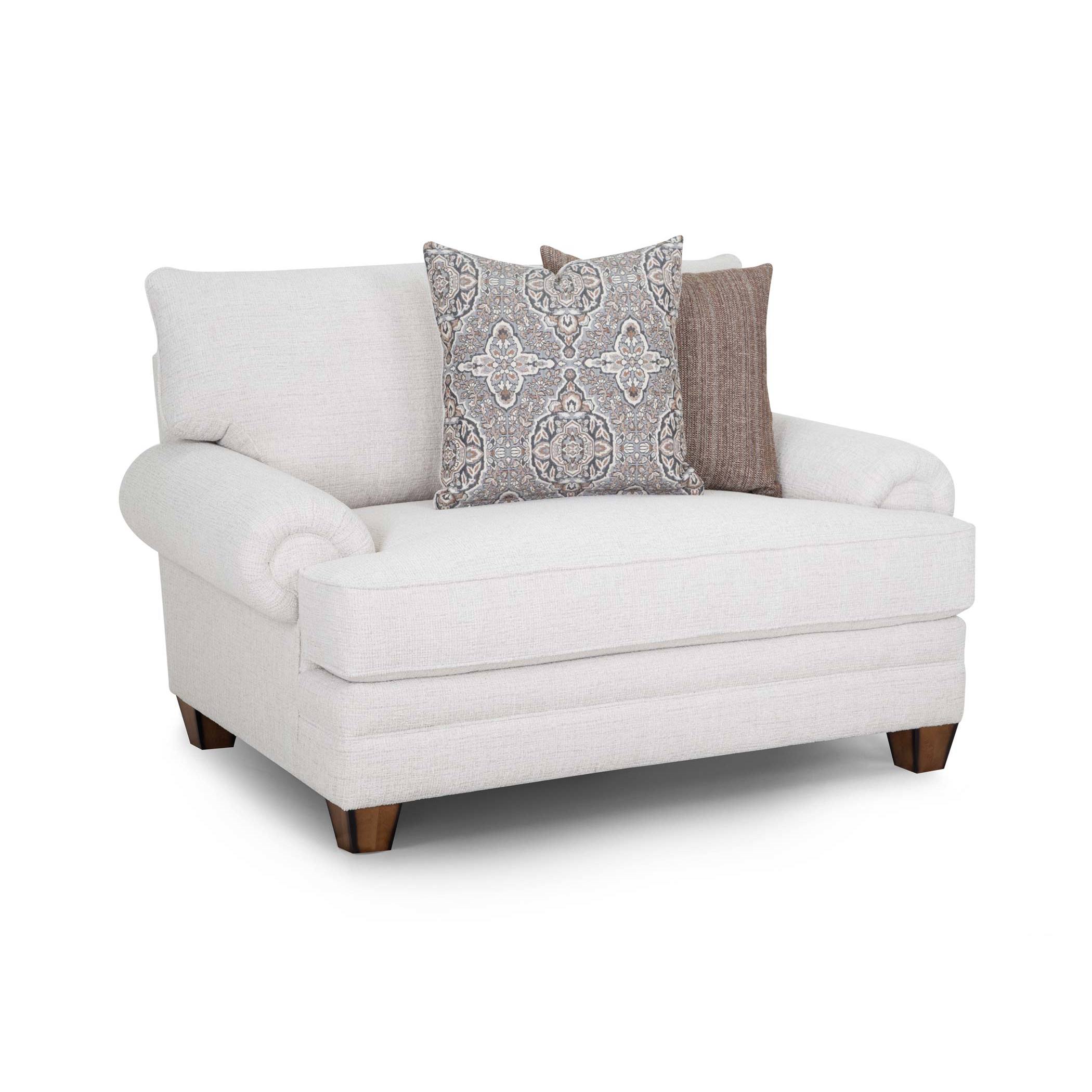 Cream upholstered chair with two decorative pillows.