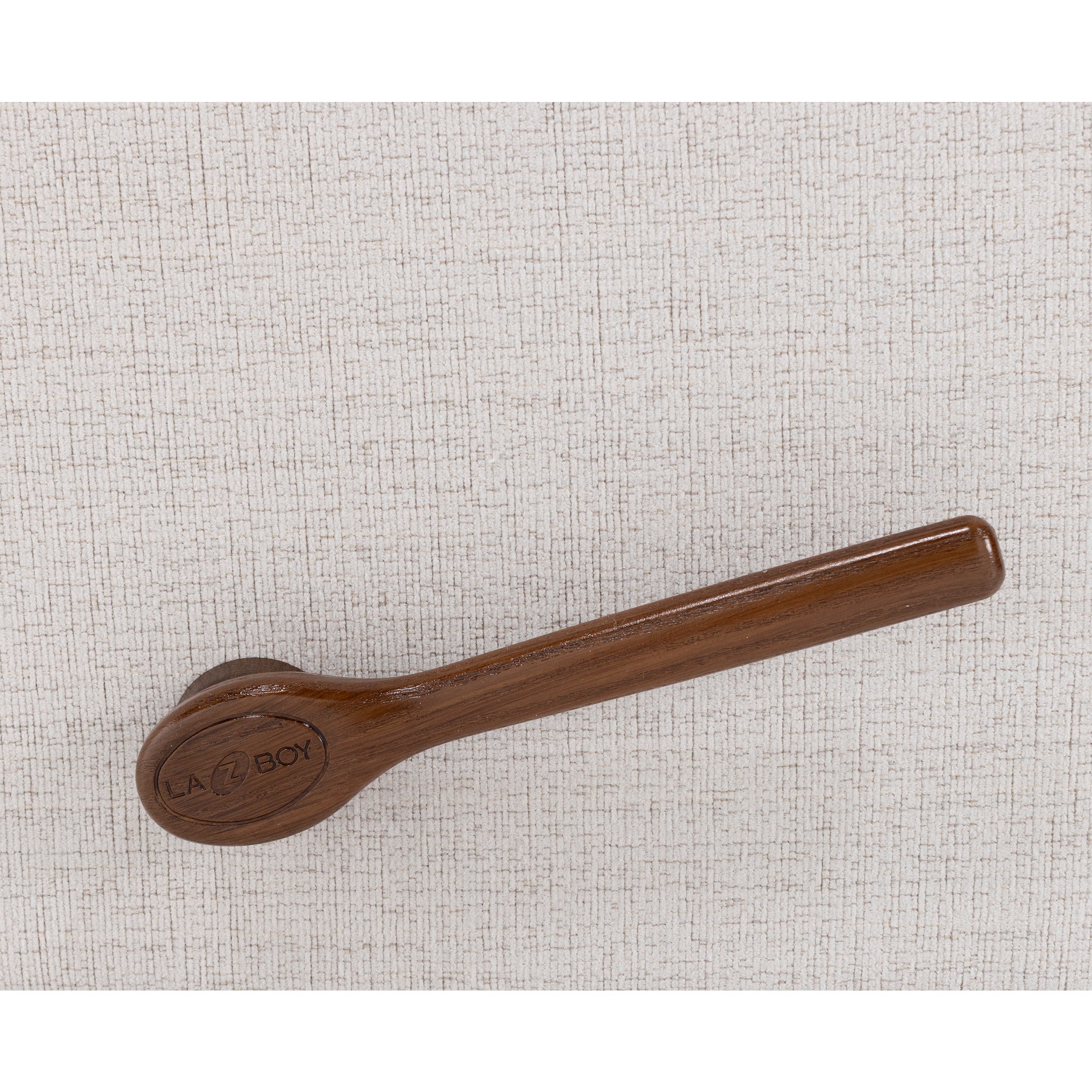Wooden recliner handle on textured beige upholstery.