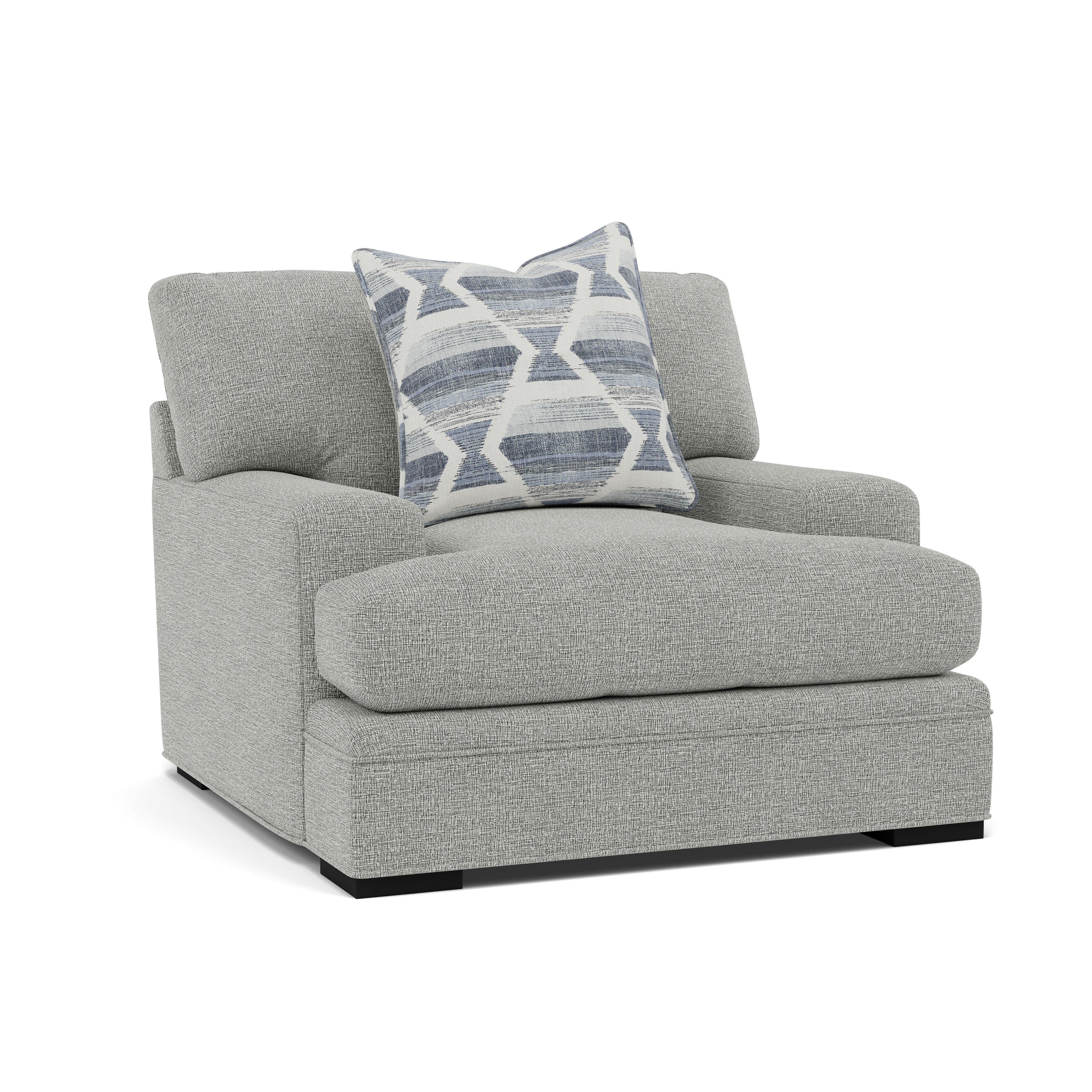 Light gray upholstered chair with a blue geometric accent pillow.