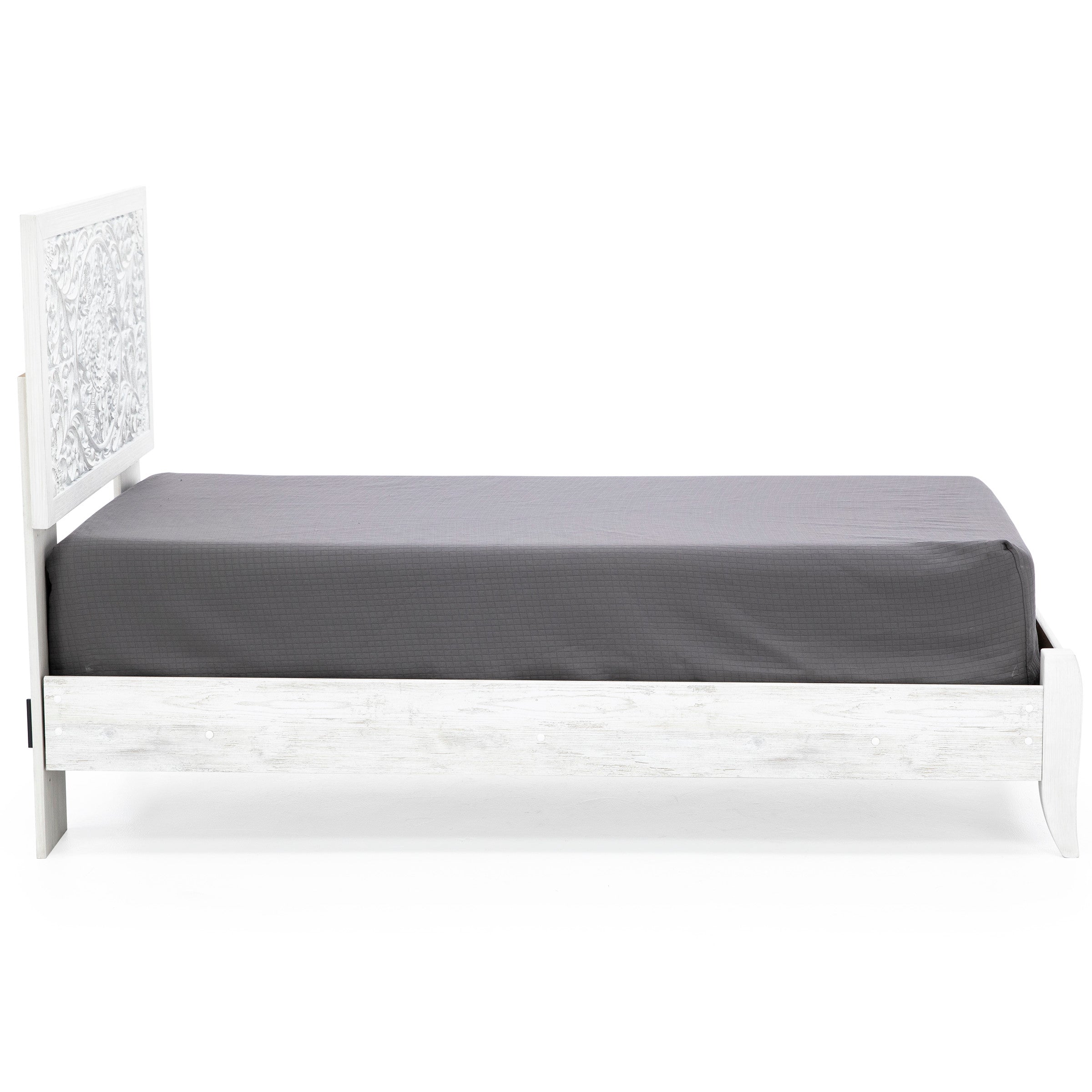 White twin bed with carved headboard and gray mattress, side view.