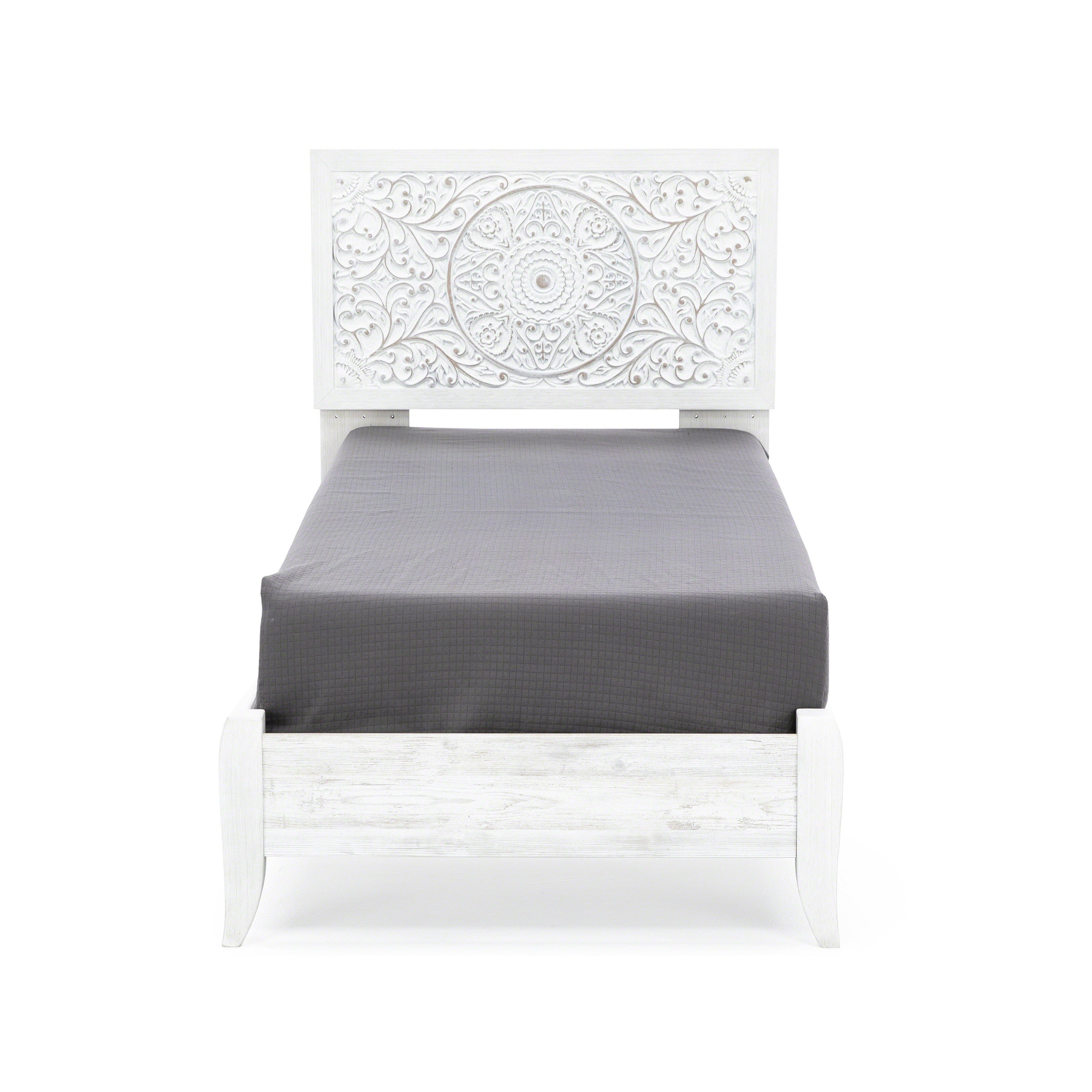 White wooden bed with intricate carved headboard, shown with dark gray bedding.