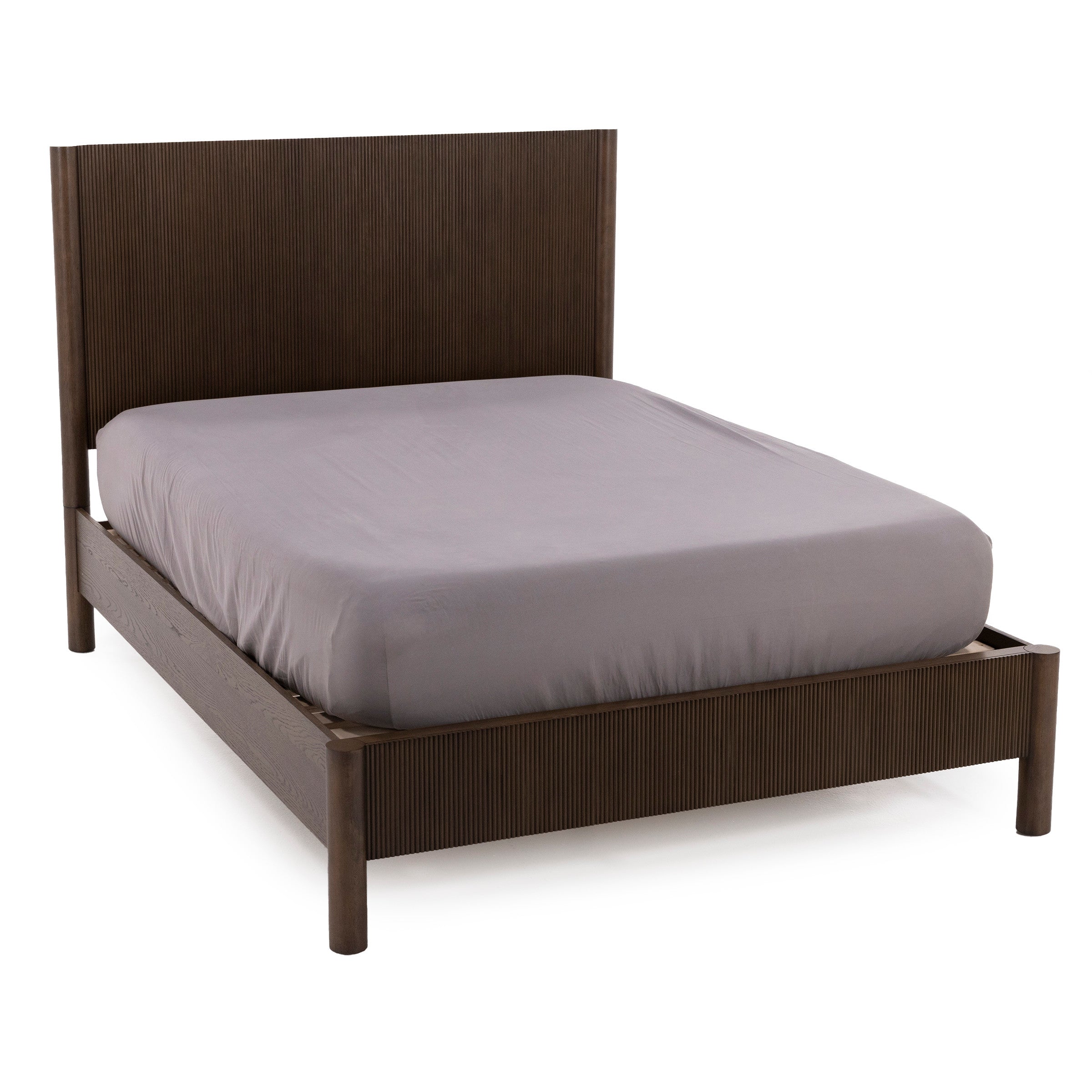 Dark wood bed frame with a high headboard and light gray fitted sheet.