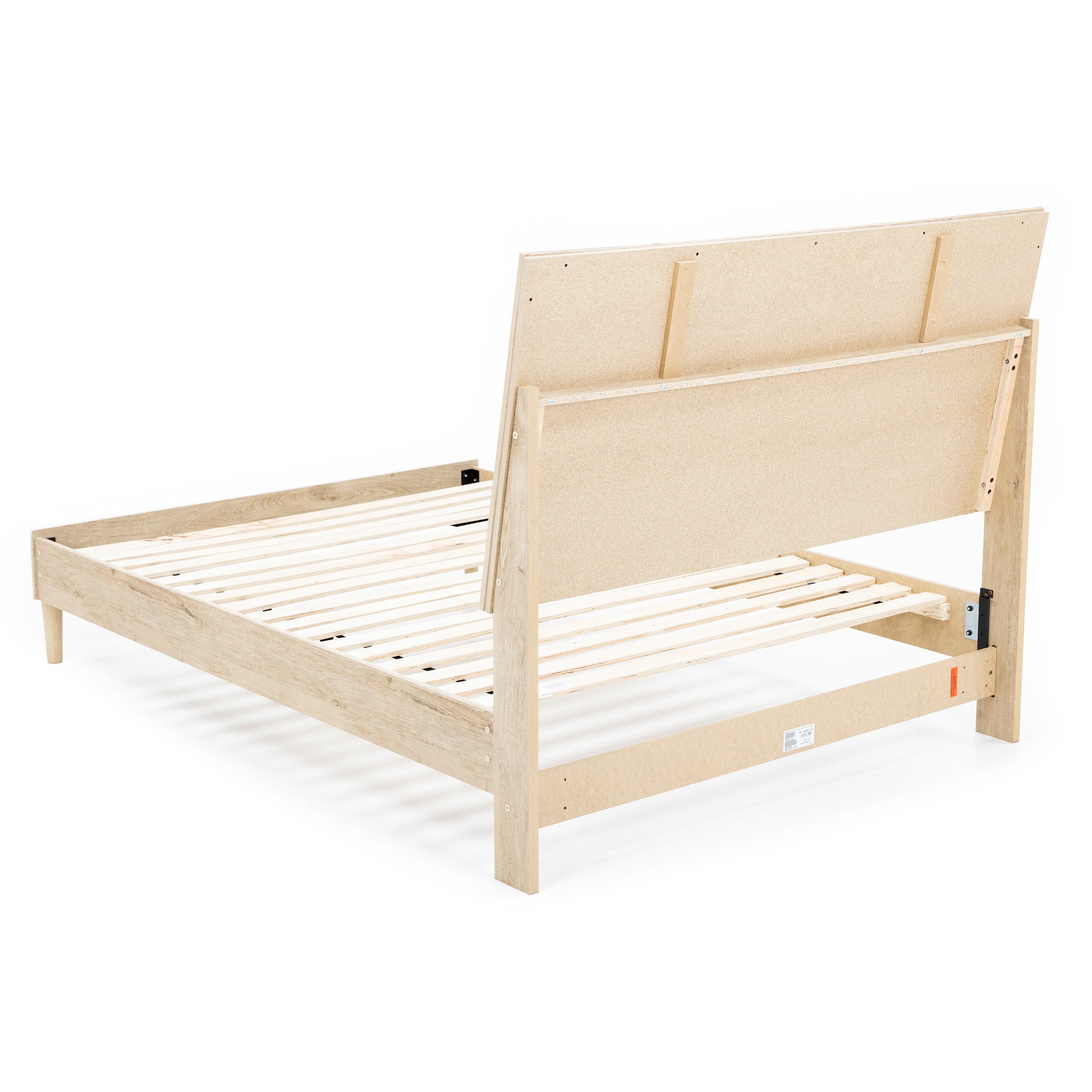 Back view of a wooden bed frame with slatted base and angled headboard.