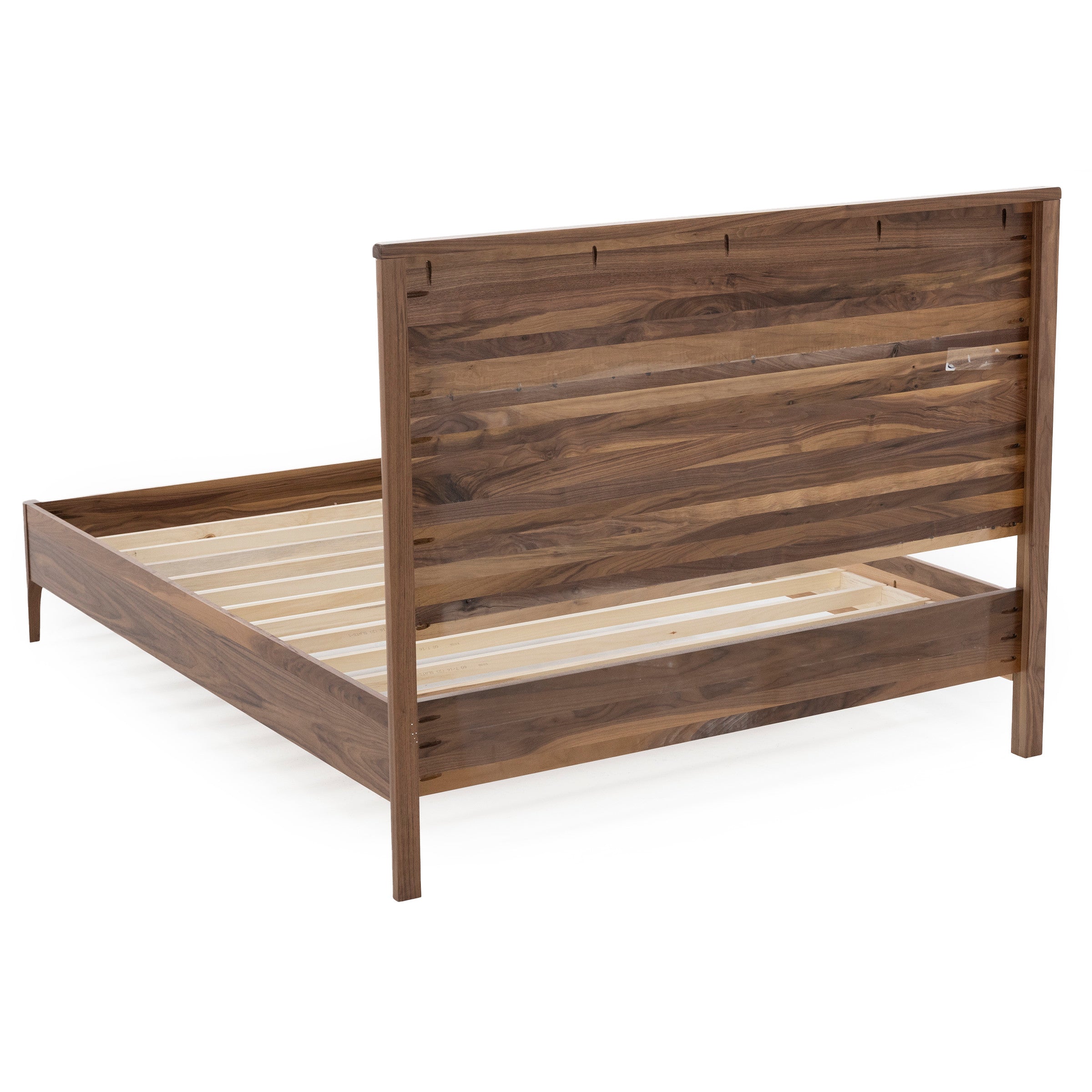 Wooden bed frame with horizontal slat headboard, shown in a rear side view.