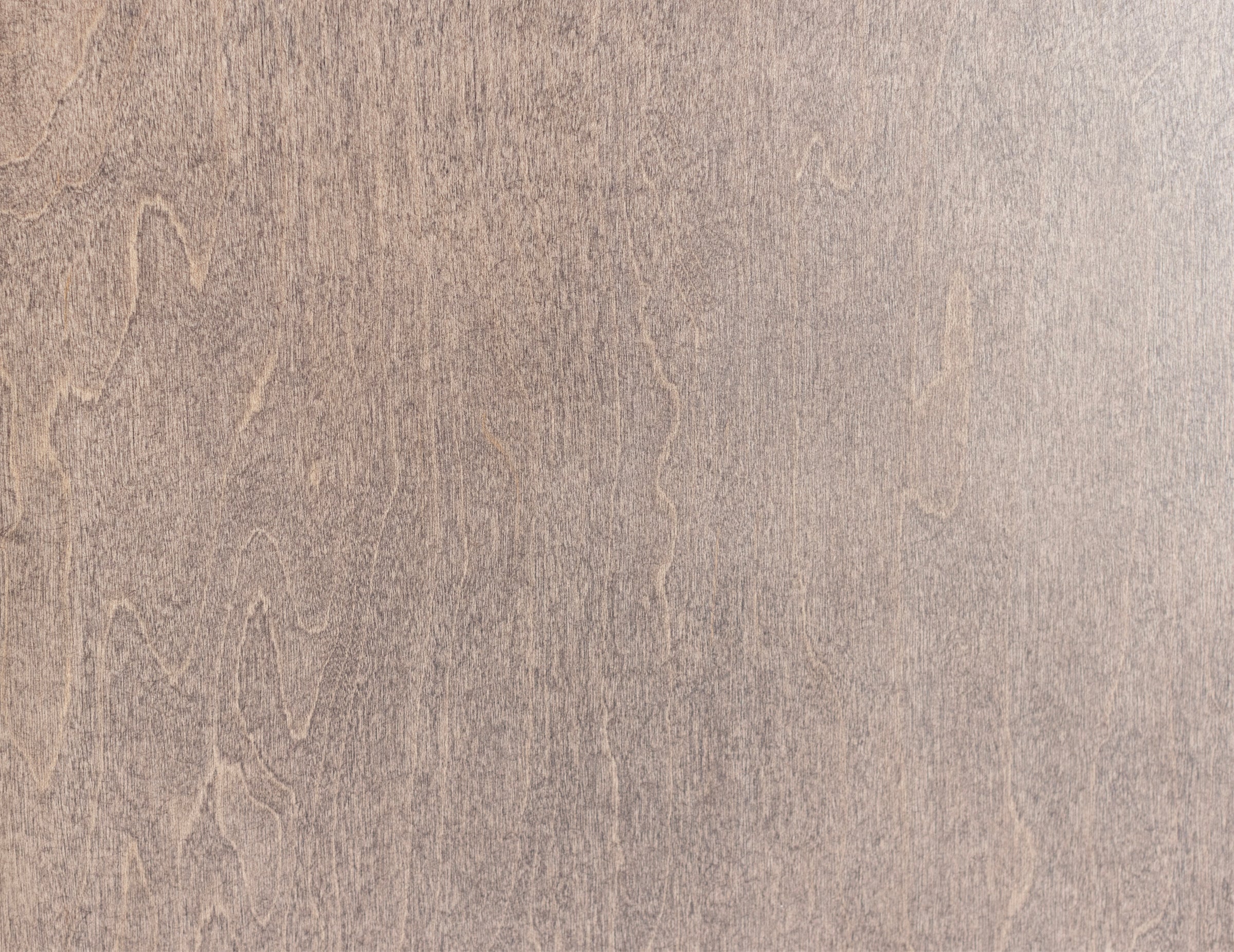 Light brown wood texture with subtle grain pattern.