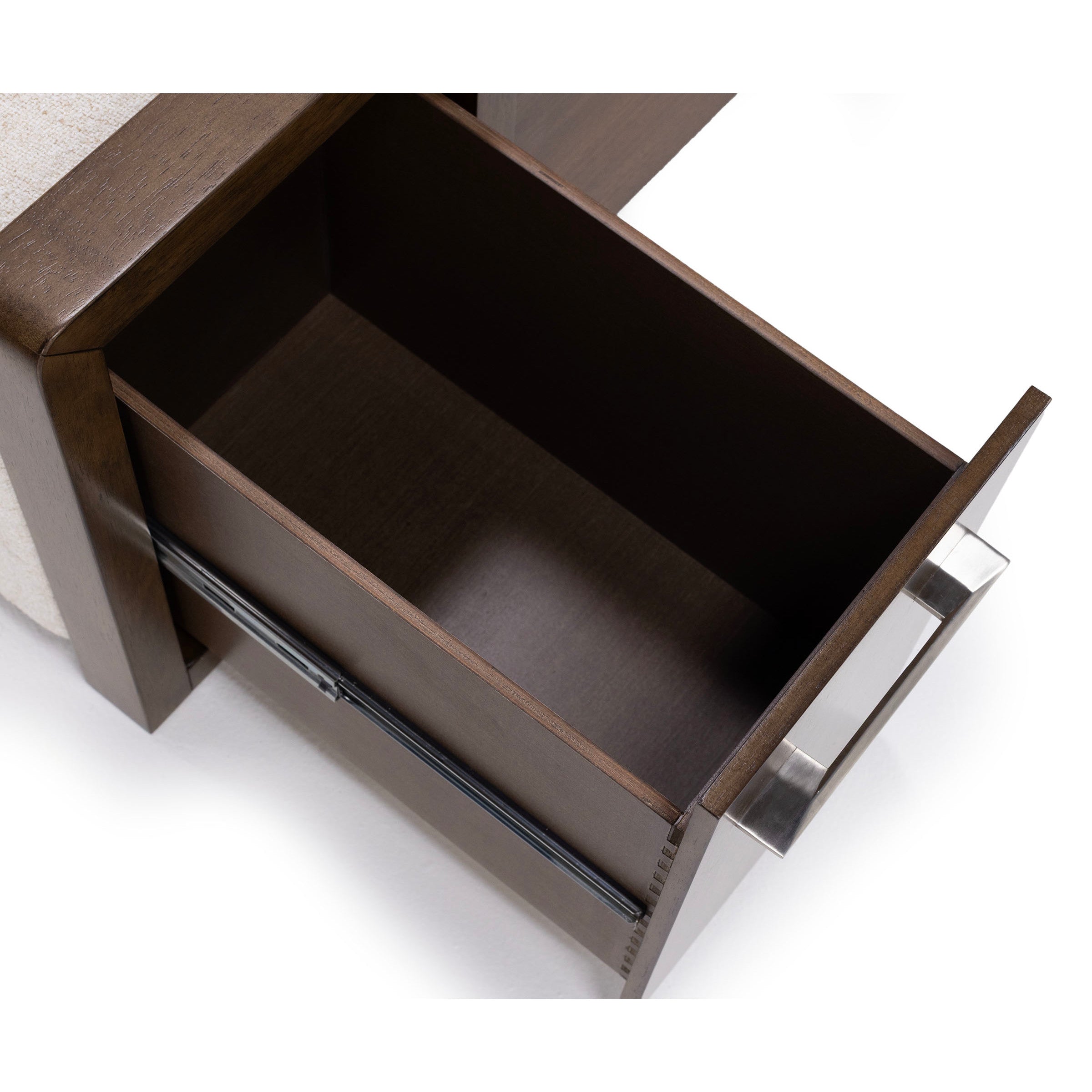 Open wooden drawer with a metal handle, shown from above.